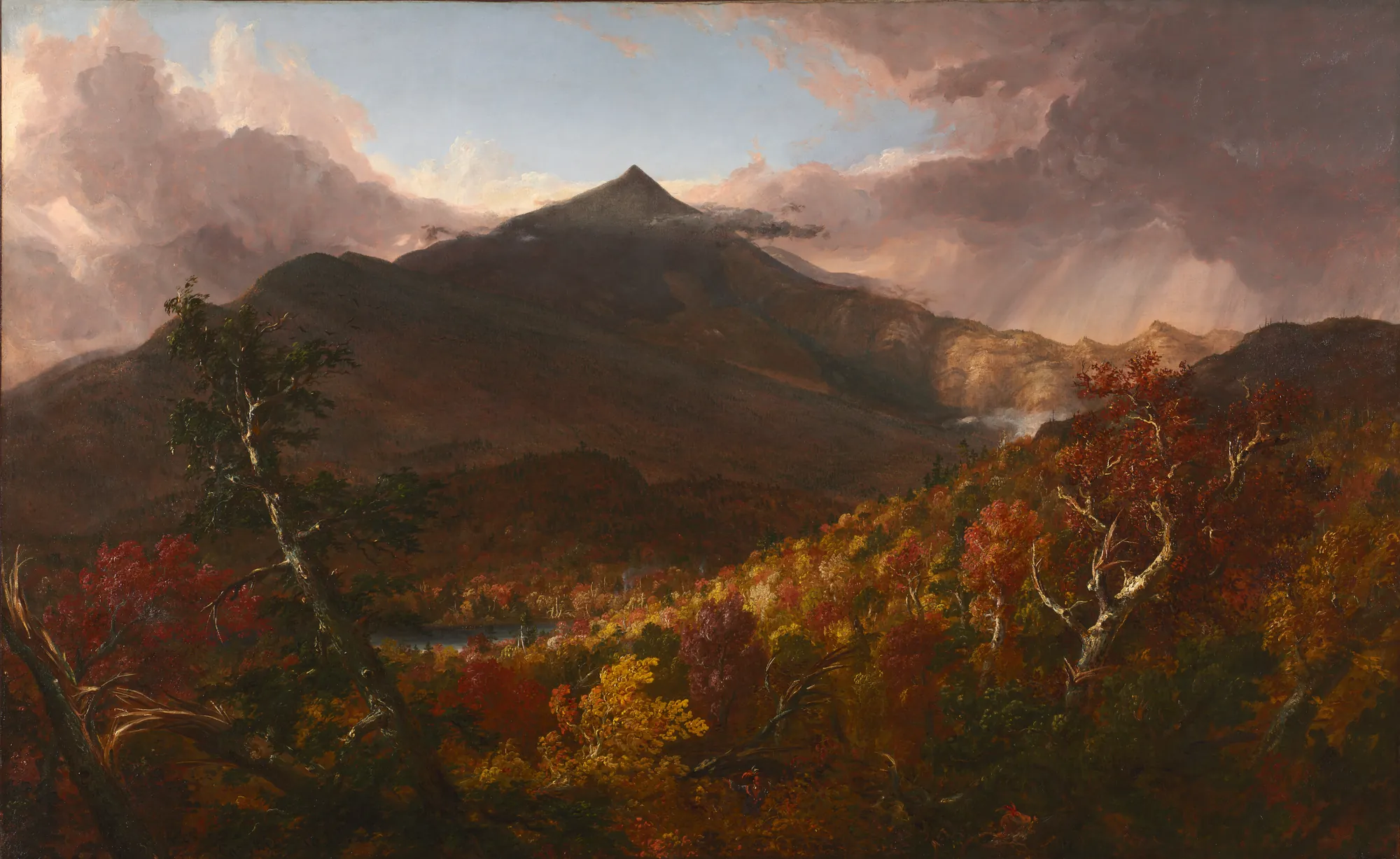 View of Schroon Mountain, After a Storm View of Schroon Mountain, After a Storm by Thomas Cole. A majestic mountain peak rises behind a valley filled with vibrant red and gold autumn trees under a dramatic, cloud-filled sky after a storm.