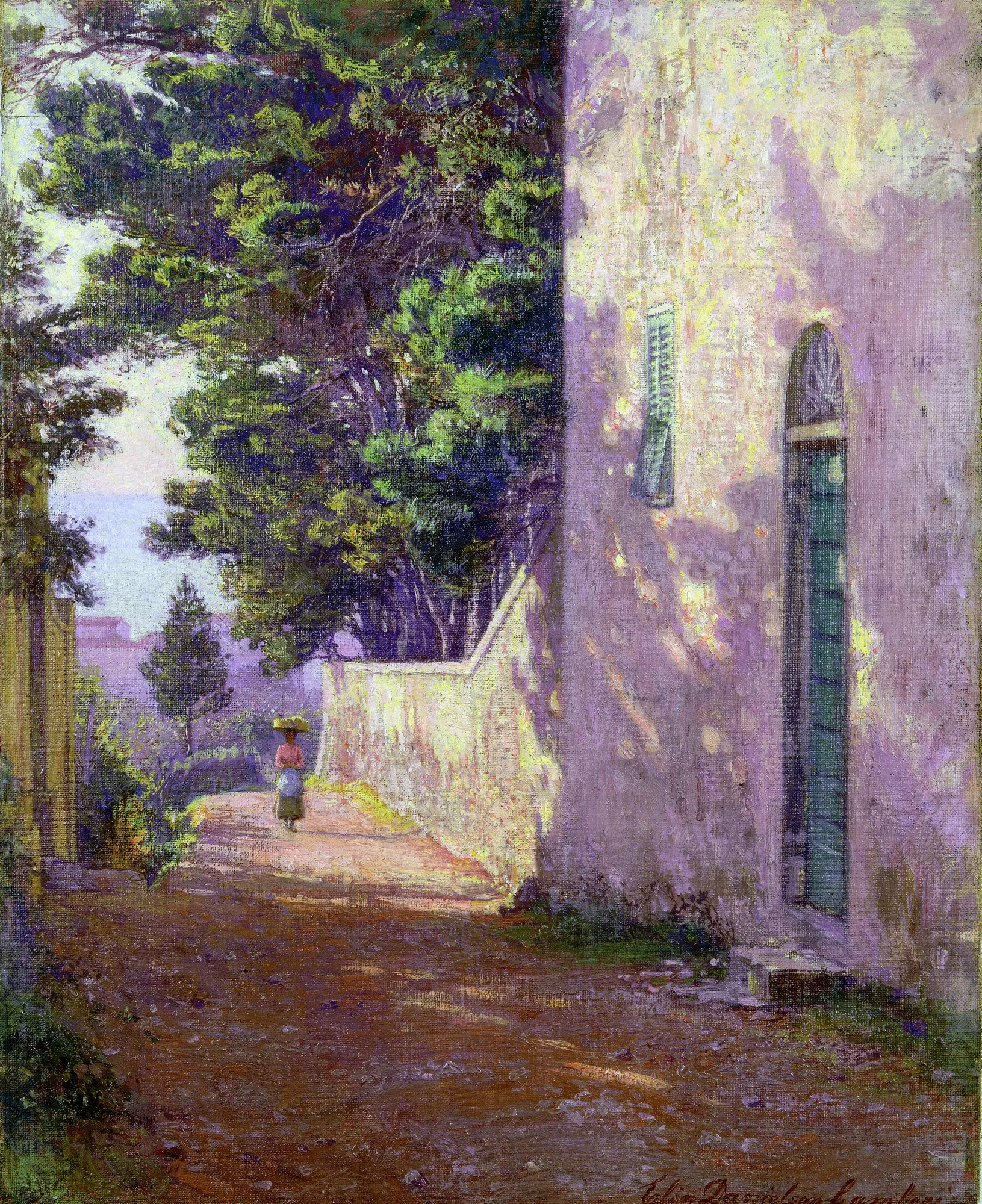 Antignano Antignano by Elin Danielson-Gambogi. A sunlit street in Antignano, Italy, with a lone woman carrying a basket on her head walking away from the viewer past a tall, dappled building.