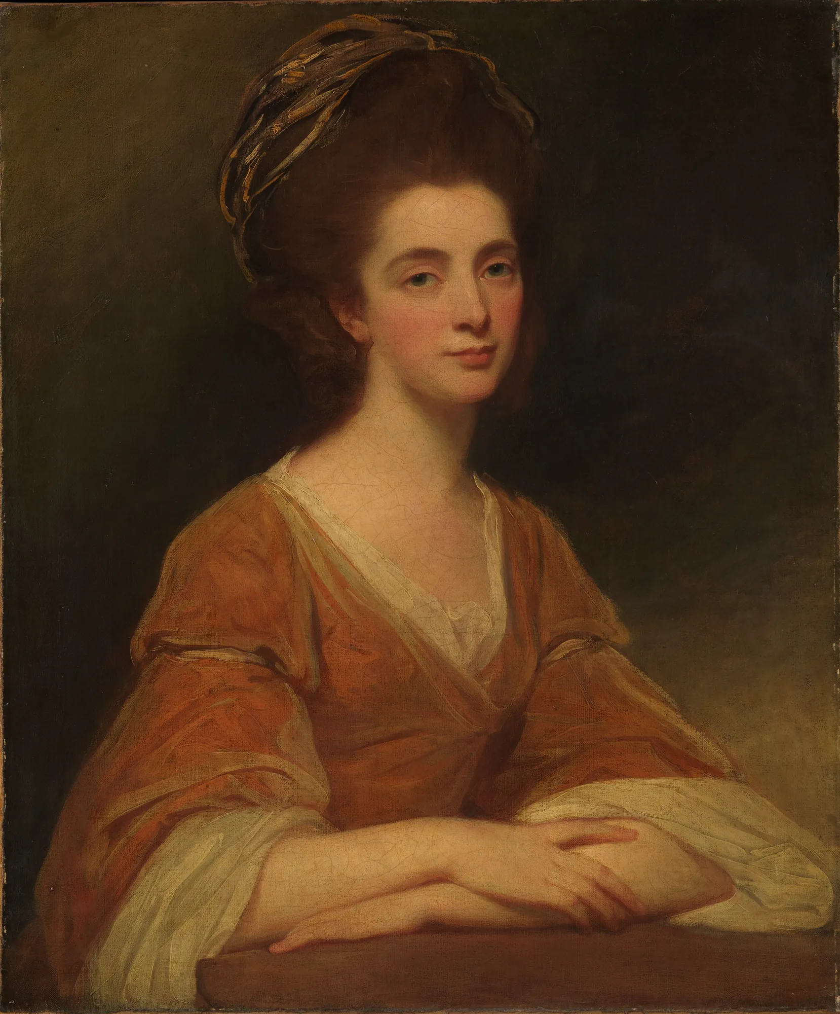 Mrs. Charles Frederick Mrs. Charles Frederick by George Romney. A classical half-length oil portrait of a woman with high-styled hair wearing a warm orange-brown dress, leaning forward with her arms crossed.
