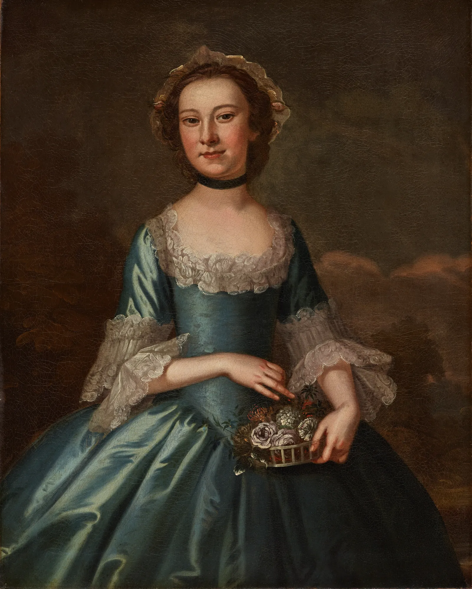 Ann Langdon, Mrs. Richard Ayscough Ann Langdon, Mrs. Richard Ayscough by John Wollaston the Younger. A formal oil portrait of a young woman in an elaborate blue satin gown holding a basket of flowers.