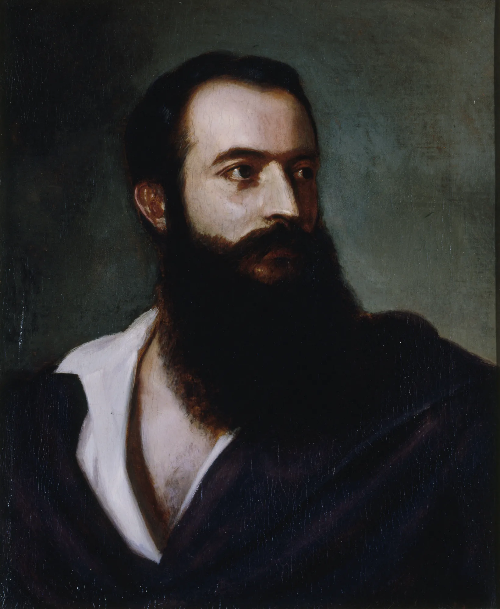 Portrait of Felice Orsini Portrait of Felice Orsini by Louis Buchheister. A portrait painting of a man with a large, dark beard and contemplative gaze, wearing a dark cloak over a white shirt.