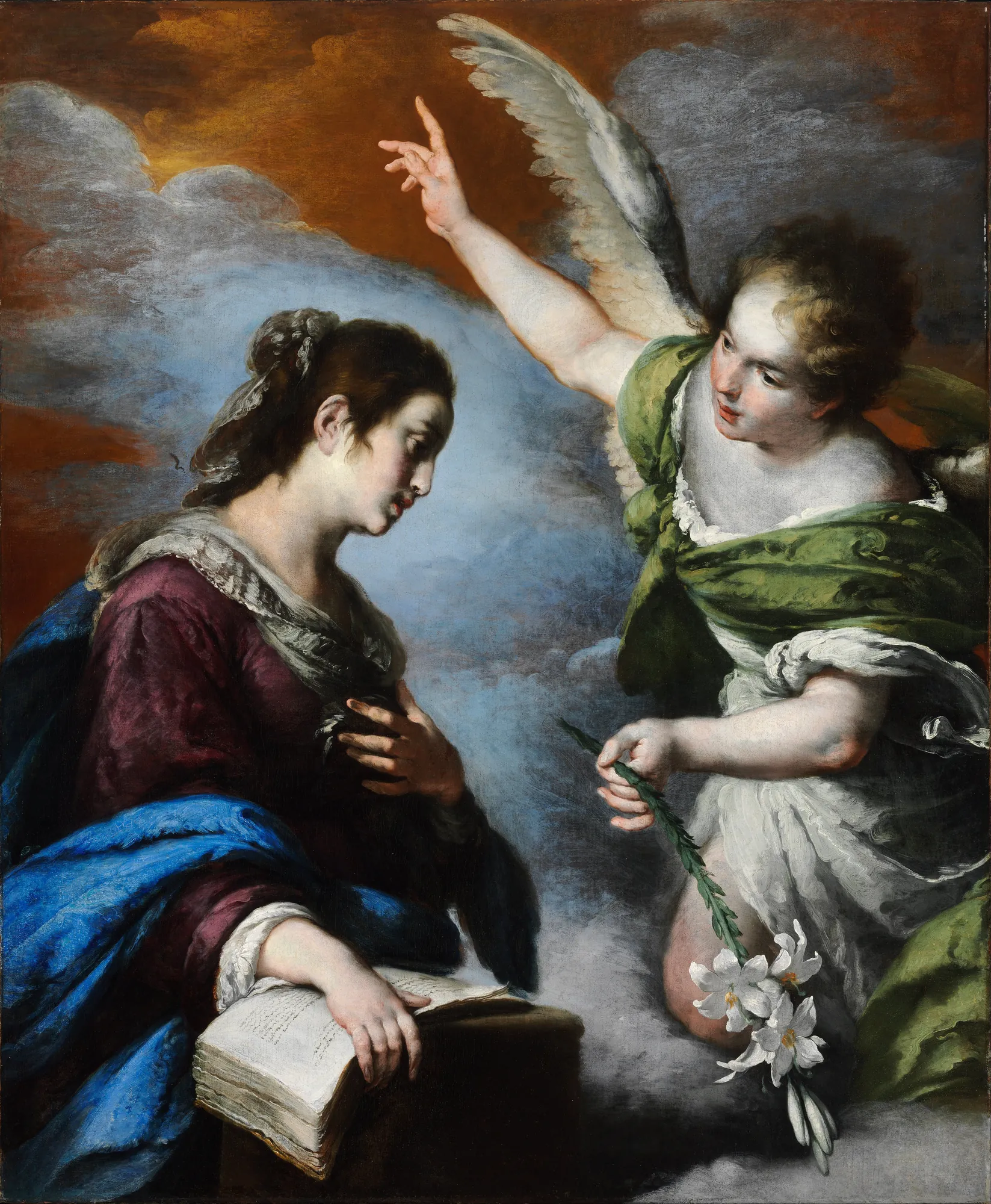The Annunciation The Annunciation by Bernardo Strozzi. The Virgin Mary looks down at an open book as the Archangel Gabriel appears with a lily, pointing towards the heavens.