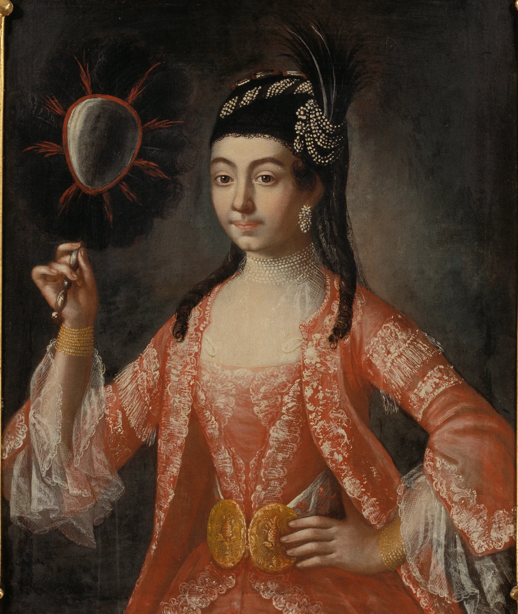 Elisabeth Palm Elisabeth Palm by Anders Eklund. A waist-length portrait of a woman in an ornate coral-colored lace gown and a feathered black headdress, holding a small handheld mirror.