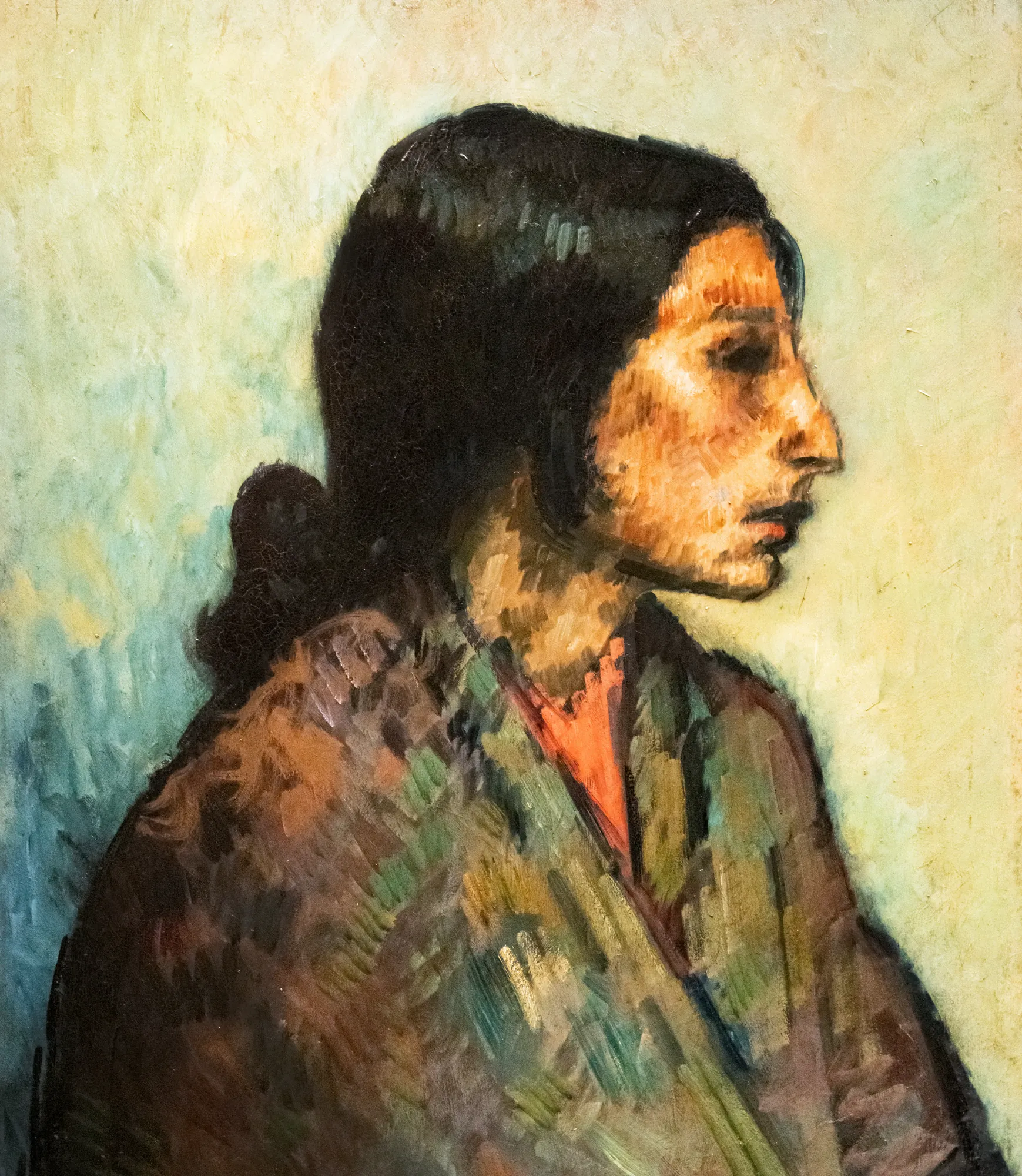 La Pelona La Pelona by Isidre Nonell. A side-profile portrait of a woman with dark hair and a patterned shawl against a light, textured background.