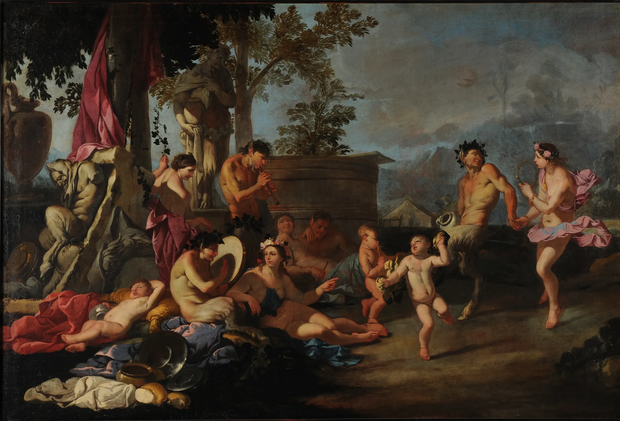 Bacchanal Bacchanal by Giulio Carpioni. A vibrant group of mythological figures, including satyrs and nymphs, are depicted in a lively celebratory scene set against a landscape with classical statuary and a clouded sky.