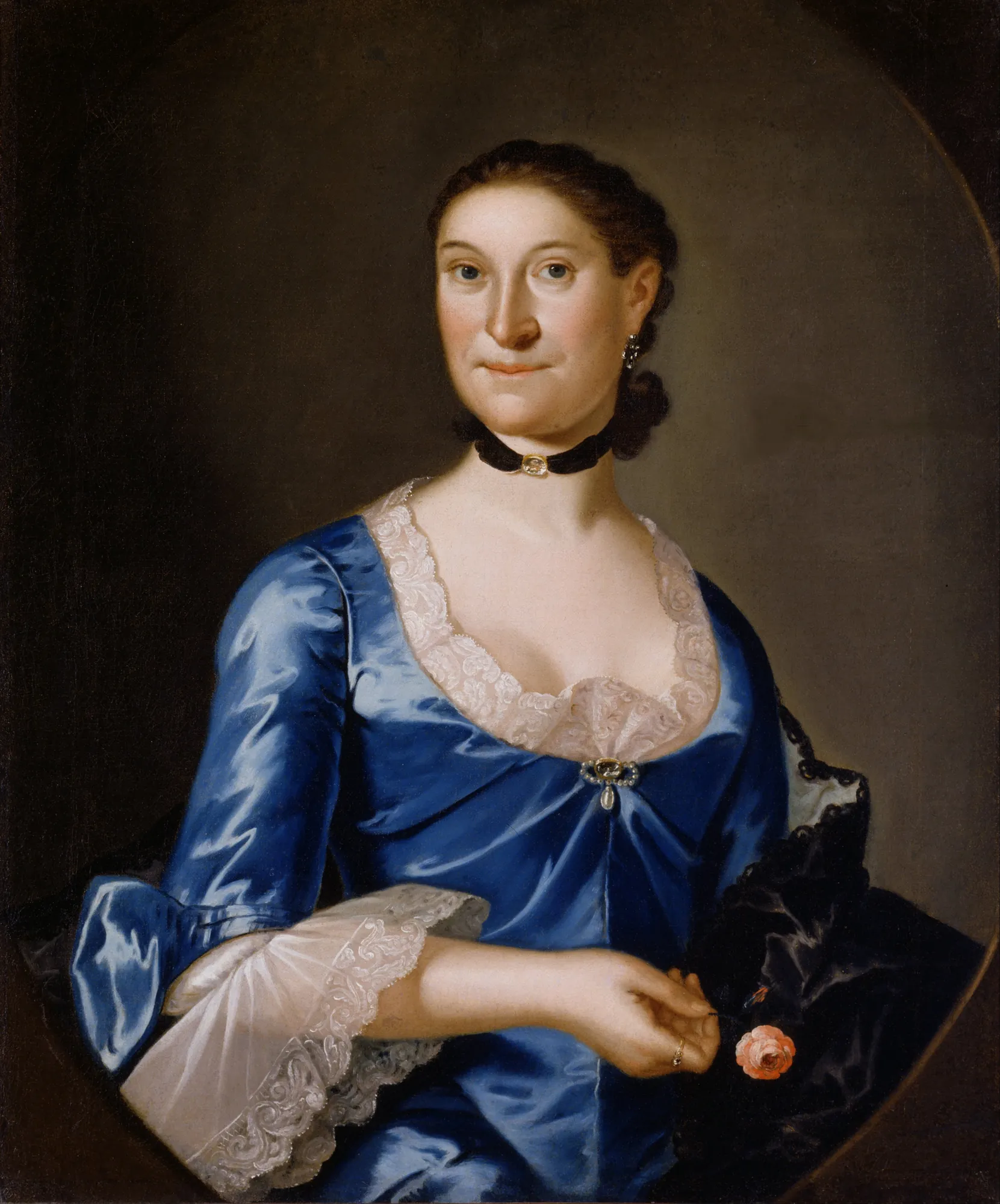 Mrs. Richard Brown Mrs. Richard Brown by John Hesselius. A half-length portrait of a woman in a shimmering blue gown with lace details, wearing a black ribbon choker and holding a single pink rose.