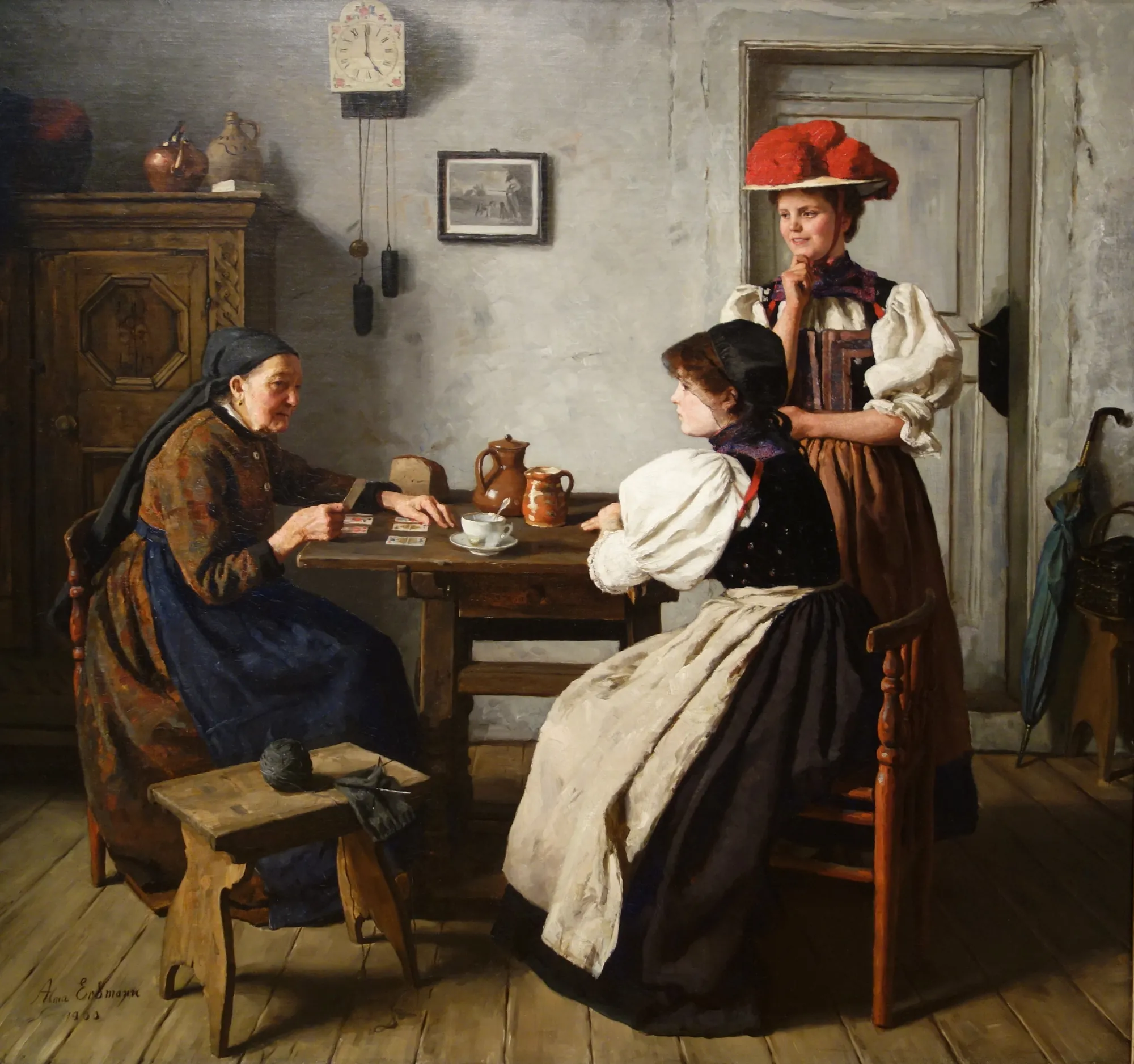 At the Fortune Teller's At the Fortune Teller's by Alma Erdmann. An elderly woman reads playing cards at a wooden table for two young women in a rustic European interior.
