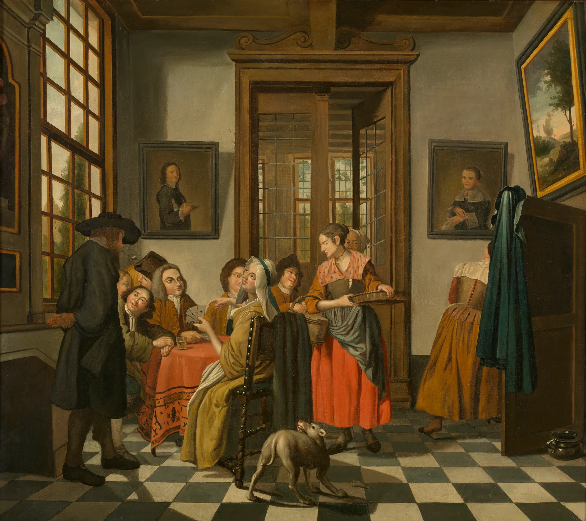 The Card Game The Card Game by Jan Josef Horemans the Younger. A group of people are gathered around a table playing cards in a tiled room while a woman serves drinks and a small dog looks on.
