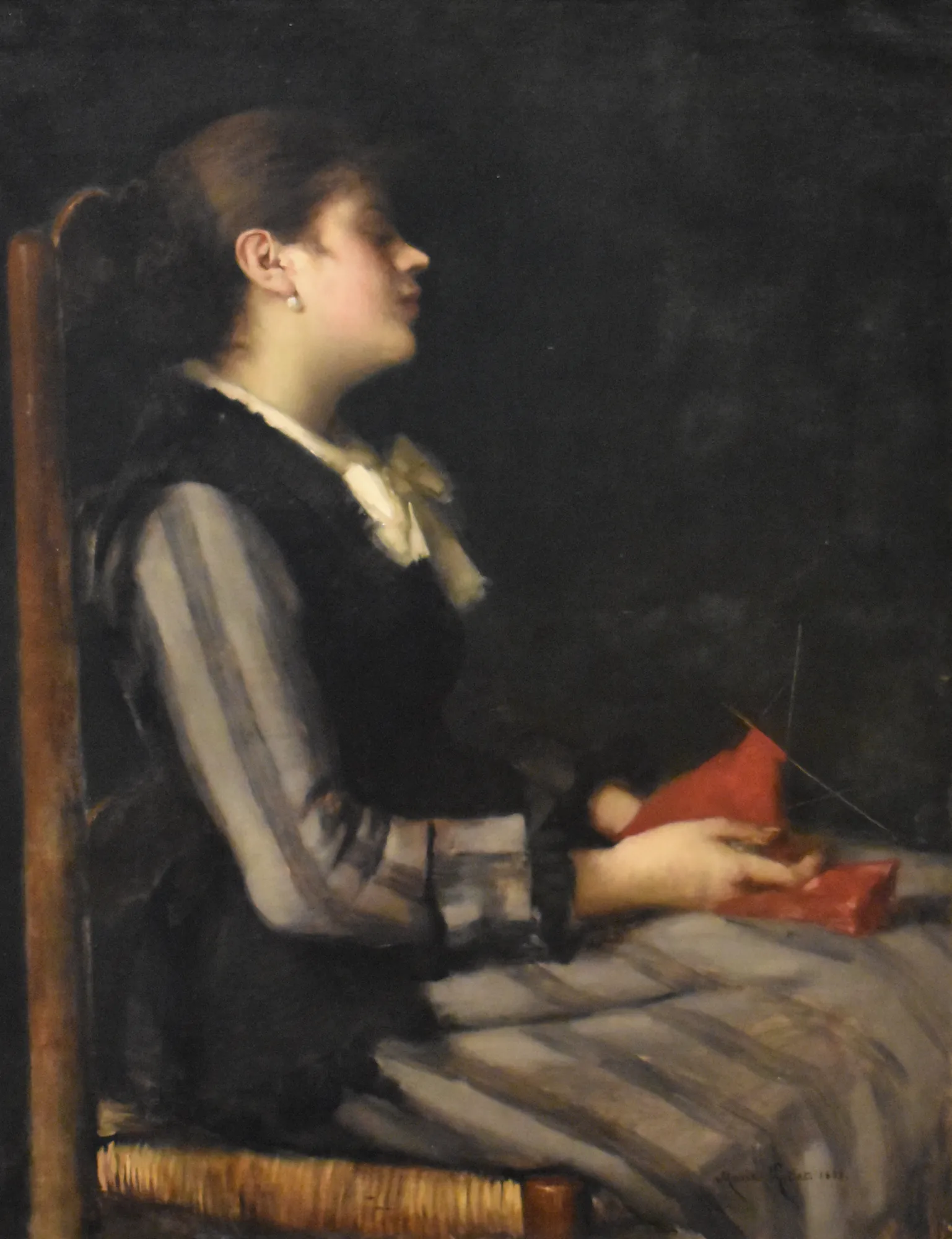 The Knitter Asleep The Knitter Asleep by Marie Petiet. A young woman is depicted in profile, seated and asleep while holding red knitting in her lap against a dark, atmospheric background.