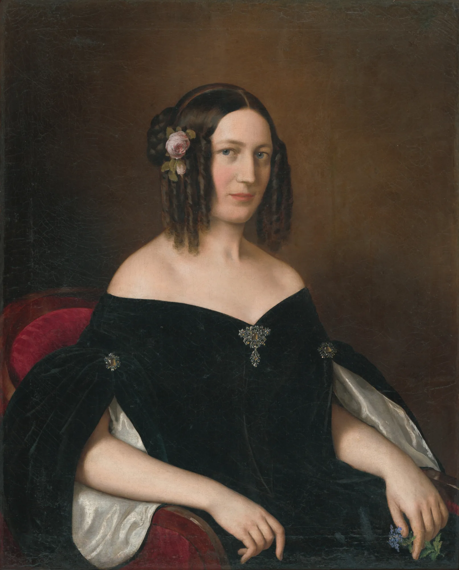Portrait of a Young Widow Portrait of a Young Widow by Miklós Barabás. A 19th-century oil portrait of a woman in a black velvet off-the-shoulder dress sitting in a red upholstered chair.