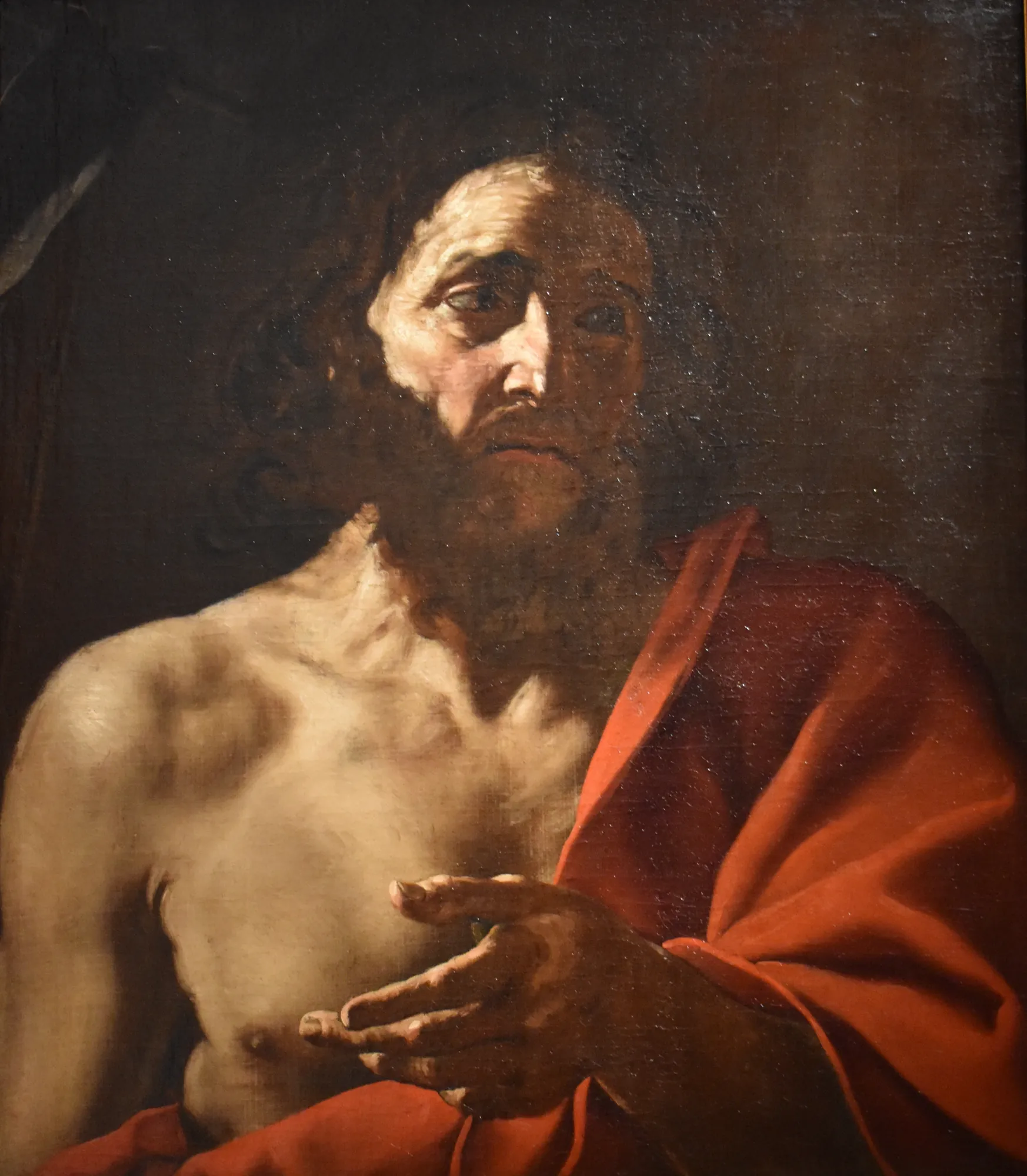 Saint John the Baptist Saint John the Baptist by Francesco Cozza. A bearded man in a red cloak is depicted in a half-length portrait with dramatic lighting from above.