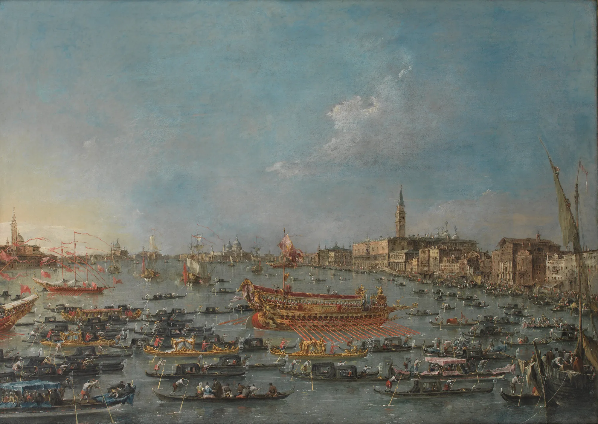 The Bucintoro Festival in Venice The Bucintoro Festival in Venice by Francesco Guardi. A crowded Venetian lagoon bustling with golden barges and gondolas during a festival, with the Doge's Palace visible in the distance under a vast blue sky.