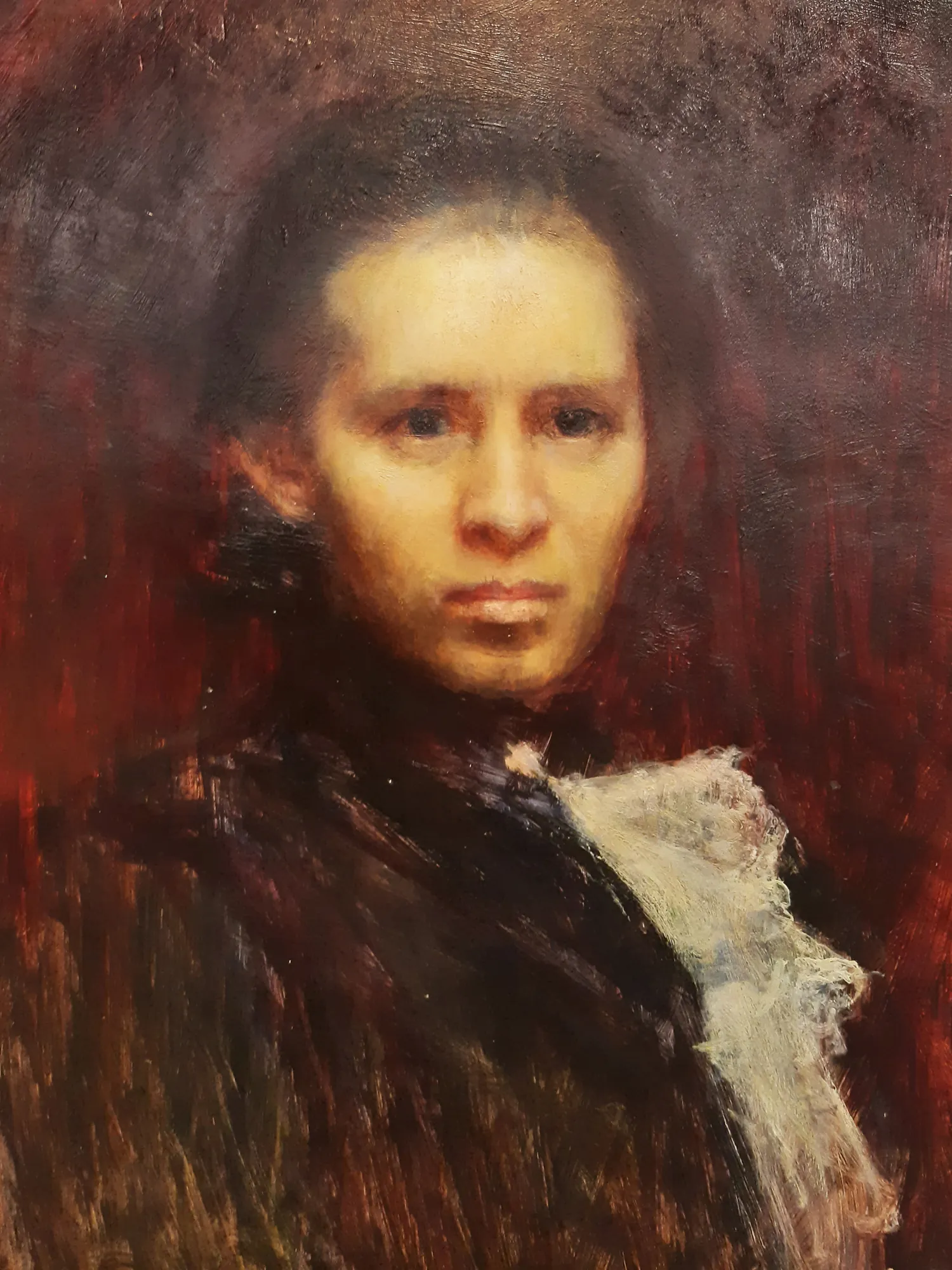 Portrait of Lesya Ukrainka Portrait of Lesya Ukrainka by Ivan Trush. An oil portrait of a woman with dark hair and a white lace collar, set against a dark, textured mahogany-toned background.