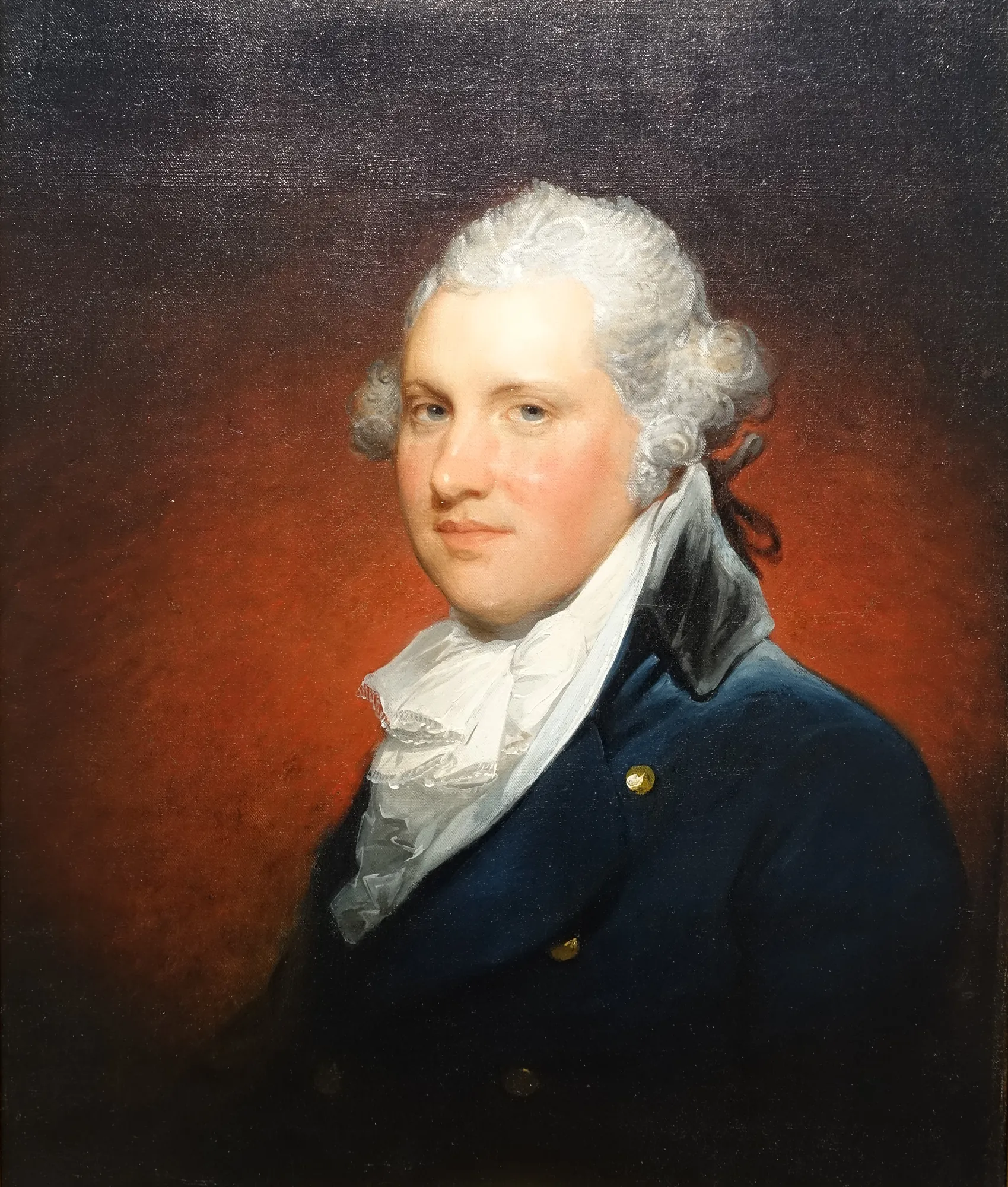 James Greenleaf James Greenleaf by Gilbert Stuart. A bust-length portrait of a man with powdered hair, wearing a dark blue coat and a ruffled white cravat against a warm, dark background.