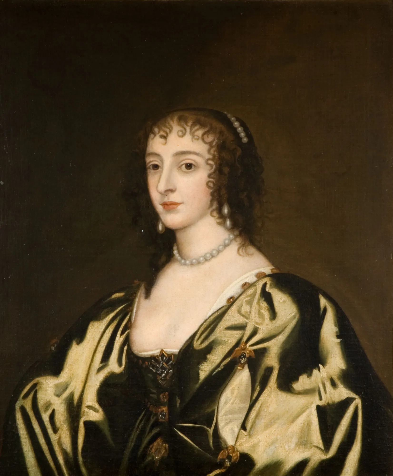 Queen Henrietta Maria Queen Henrietta Maria by Anthony van Dyck. A half-length portrait of a woman with dark curly hair wearing a shimmering golden-olive gown and pearl accessories against a dark background.
