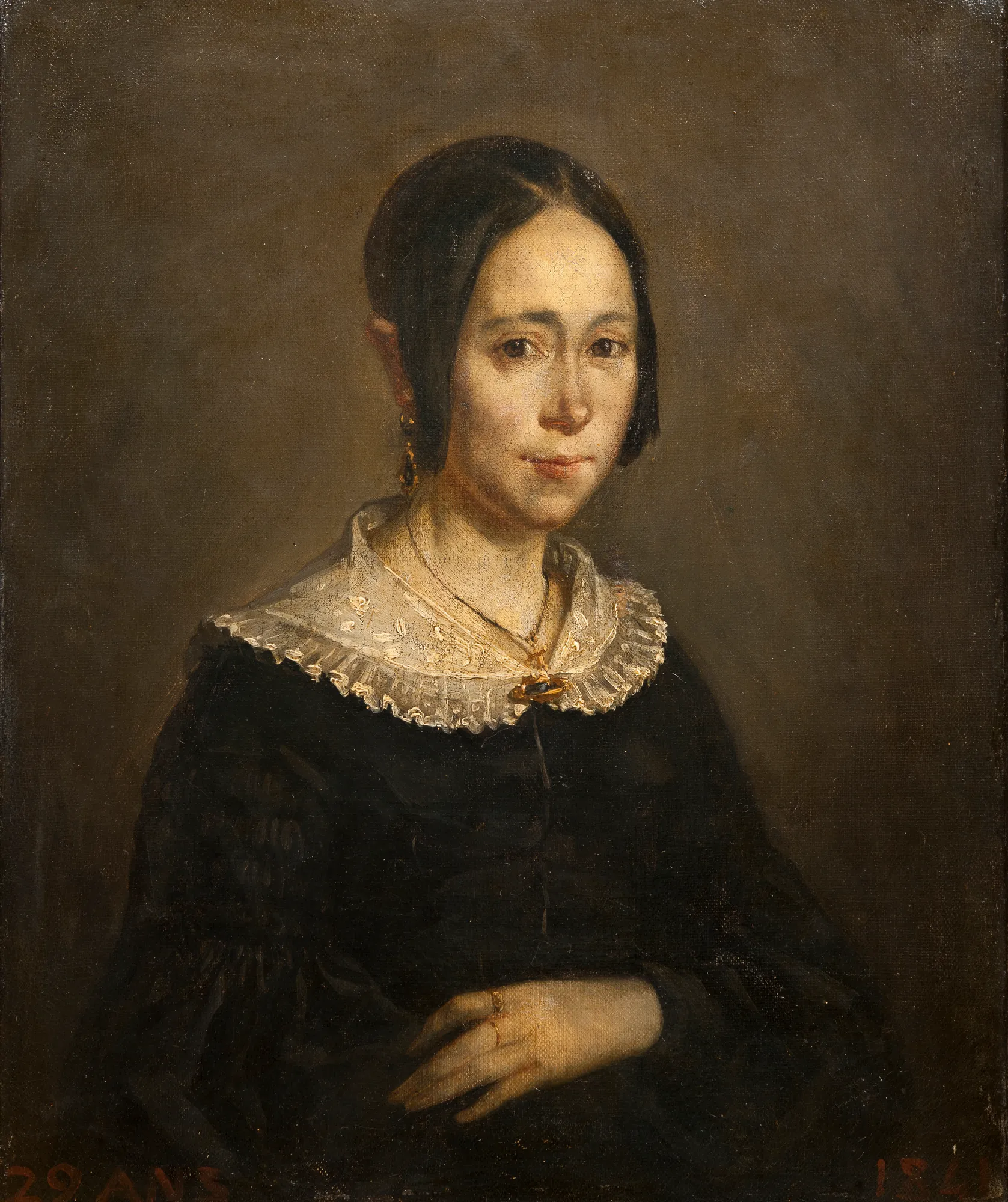 Madame Frigot Madame Frigot by Jean-François Millet. A portrait of a woman with dark hair and a lace collar against a dark, neutral background.