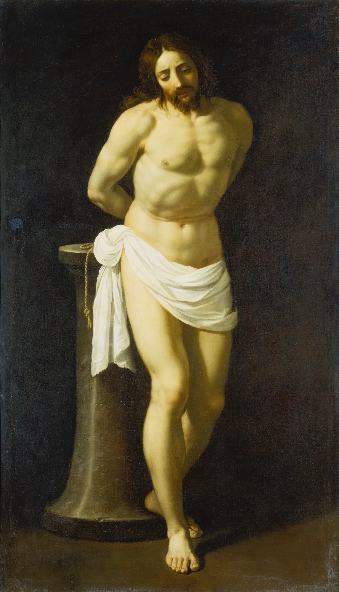 Christ at the Column Christ at the Column by Guido Reni. A standing male figure with a beard and long hair is bound by his hands to a stone column, wearing a white loincloth against a dark, shadowy background.