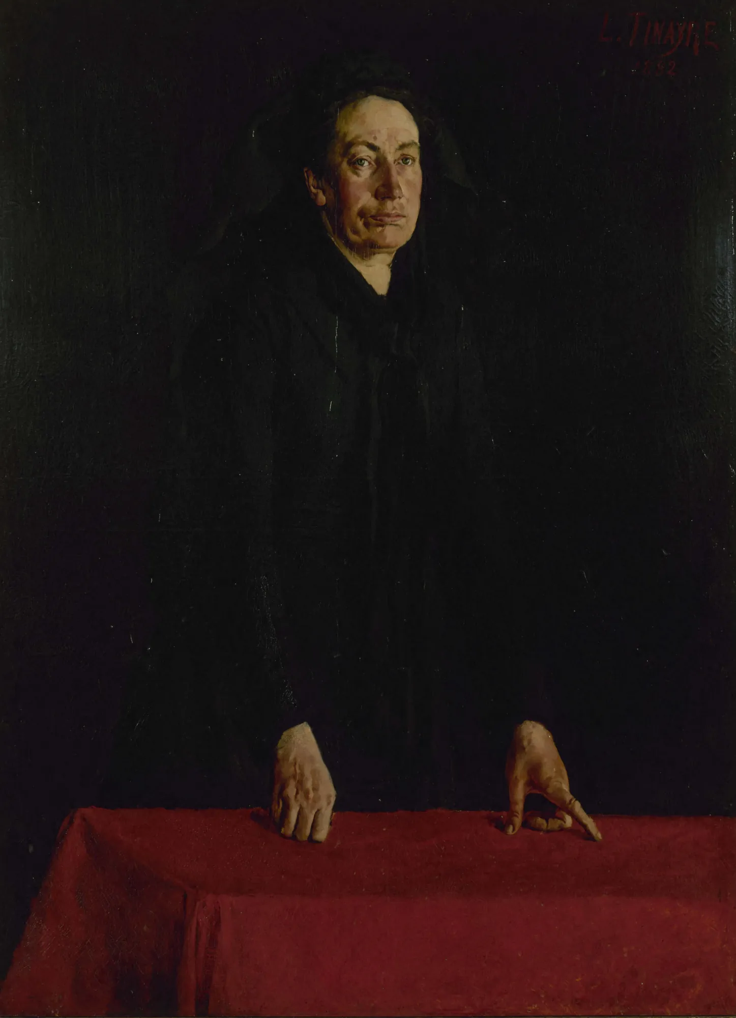 Louise Michel Louise Michel by Louis Tinayre. A woman in dark clothing stands with hands on a table draped in a vivid red cloth against a black backdrop.
