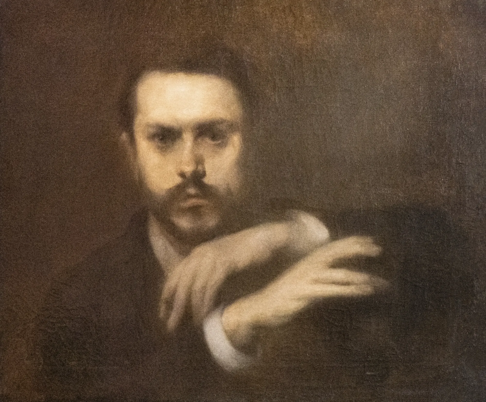 Portrait of Gustave Geffroy Portrait of Gustave Geffroy by Eugène Carrière. A monochromatic, hazy portrait of a man with a beard and moustache, resting his hands in front of him against a dark, atmospheric background.