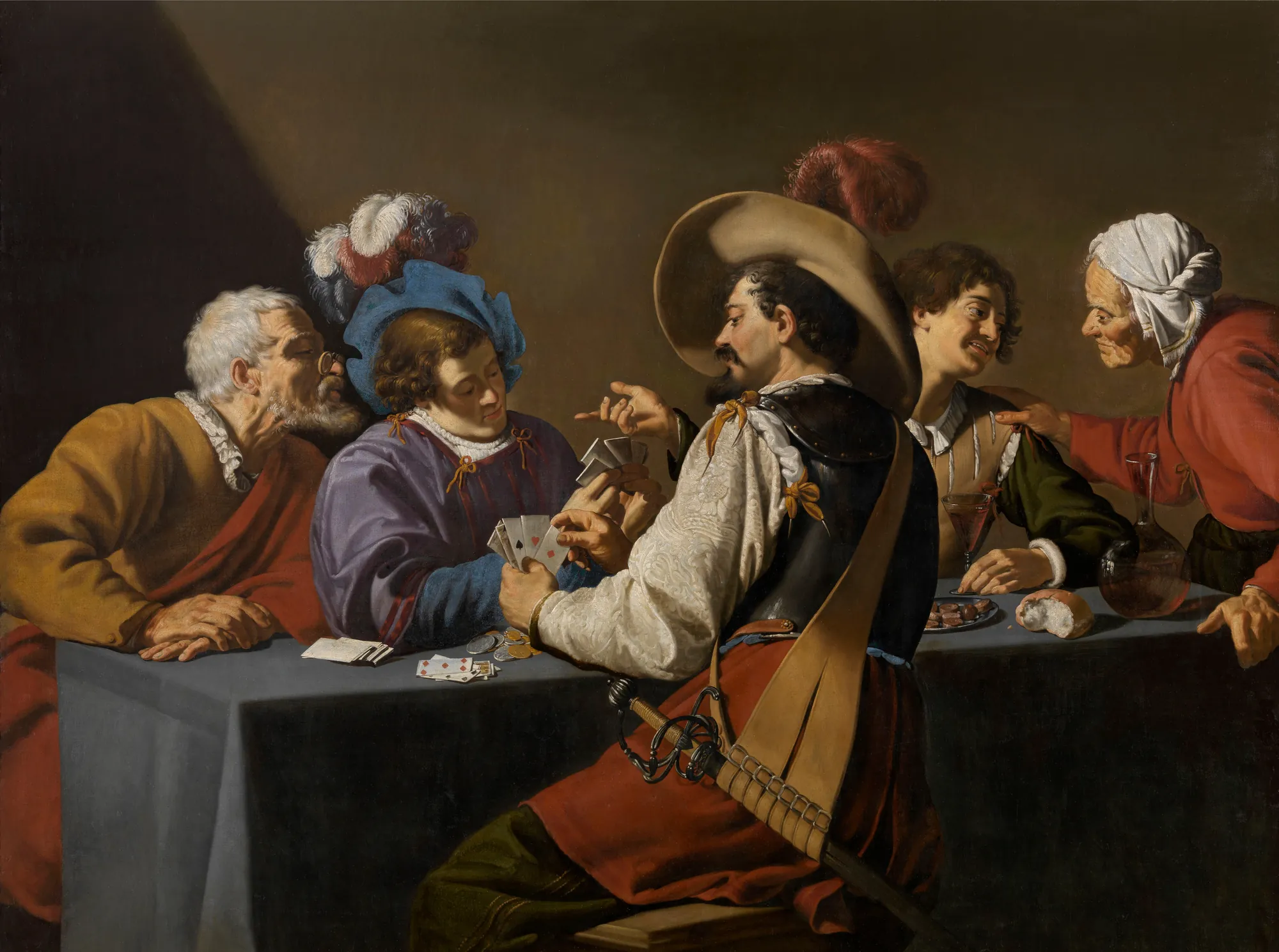 Card Players Card Players by Theodoor Rombouts. A group of five figures, including a central man in a feathered hat and breastplate, gather around a table to play cards in a dimly lit setting.