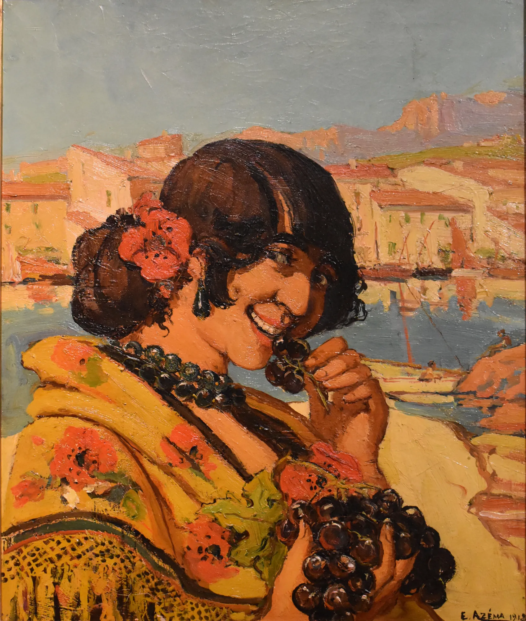 Femme mangeant une grappe de raisin Femme mangeant une grappe de raisin by Ernest Azéma. A portrait of a smiling woman in a yellow floral shawl eating dark grapes against a coastal Mediterranean backdrop.