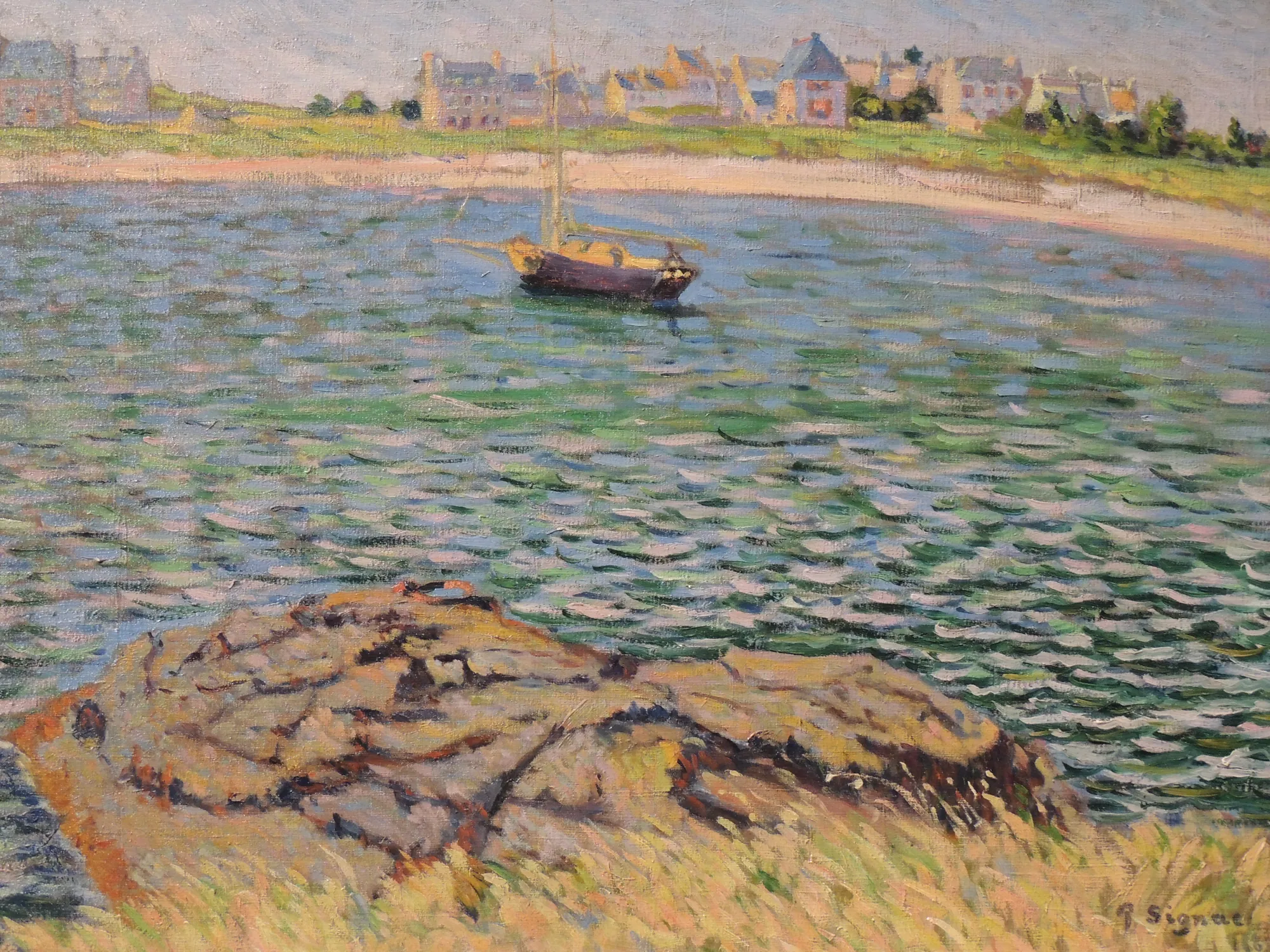 Saint-Briac, Le Béchet Saint-Briac, Le Béchet by Paul Signac. An Impressionist oil painting of a sailboat anchored in a bay with a rocky foreground and a village along the distant shoreline.