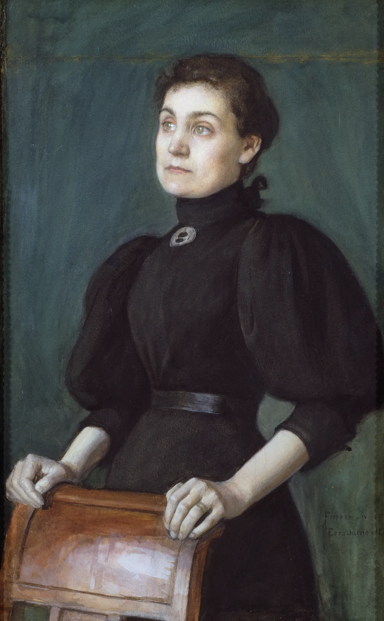 The Artist's Wife The Artist's Wife by Eero Järnefelt. A portrait of a woman in a high-necked black dress standing with her hands resting on the back of a wooden chair.