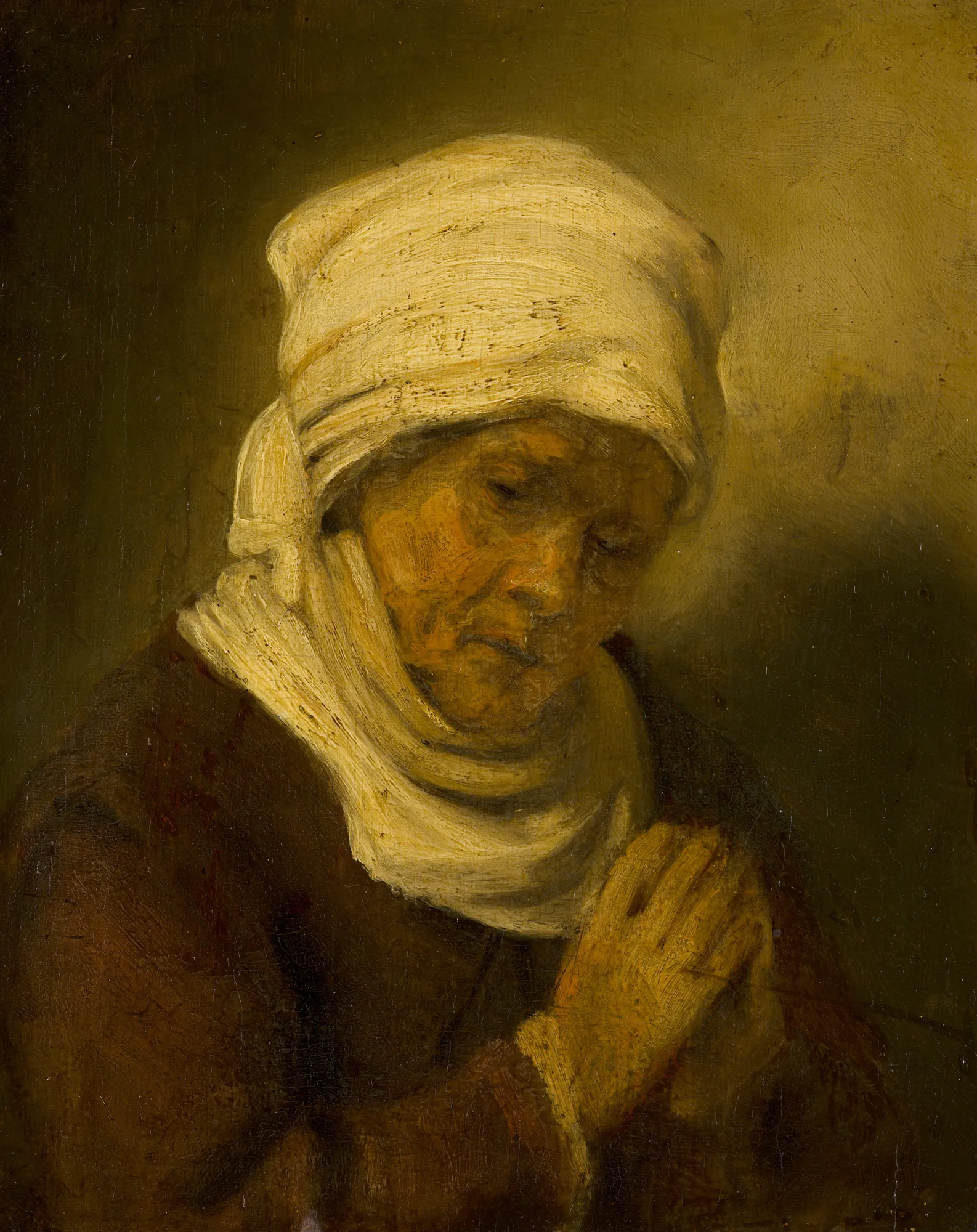 Praying Woman Praying Woman by Rembrandt. A portrait of an elderly woman with her head bowed and hands clasped in prayer, wearing a white headscarf.