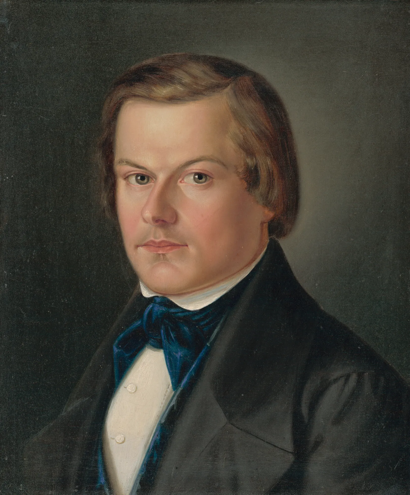 Portrait of Jakub Grajchman Portrait of Jakub Grajchman by Peter Michal Bohúň. A waist-up portrait of a young man with brown hair, wearing a black coat and a vibrant blue cravat against a dark, neutral background.