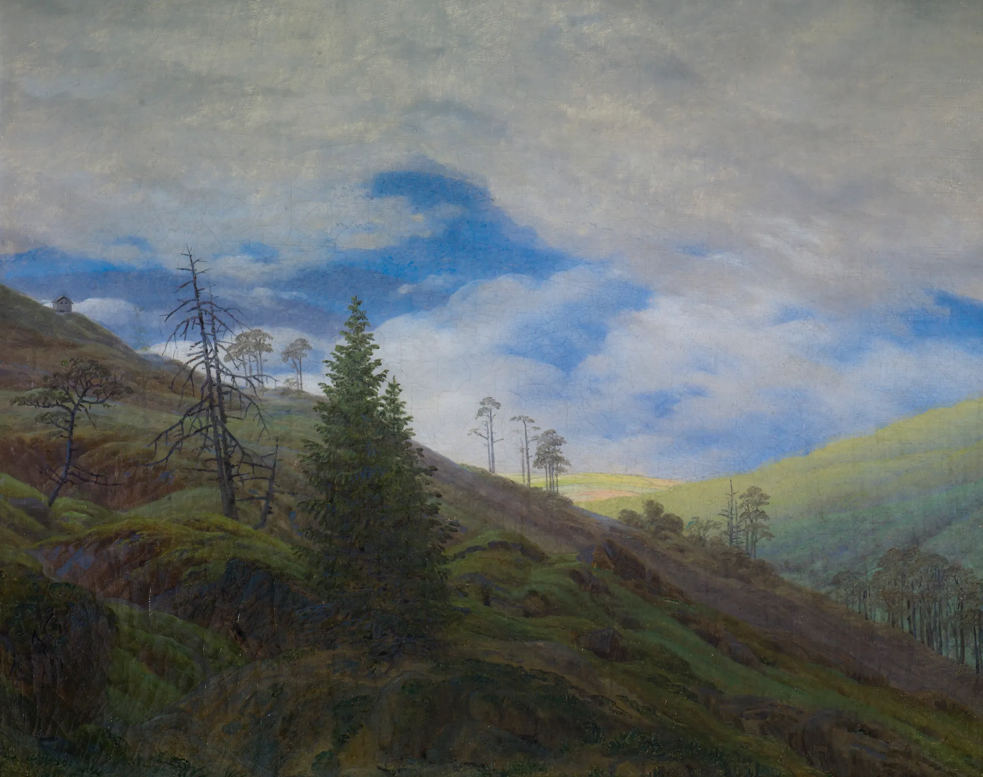 Sunburst in the Riesengebirge Sunburst in the Riesengebirge by Caspar David Friedrich. A misty mountain landscape featuring a cluster of pine trees on a rocky hillside under a dramatic, cloud-filled sky with light breaking through.