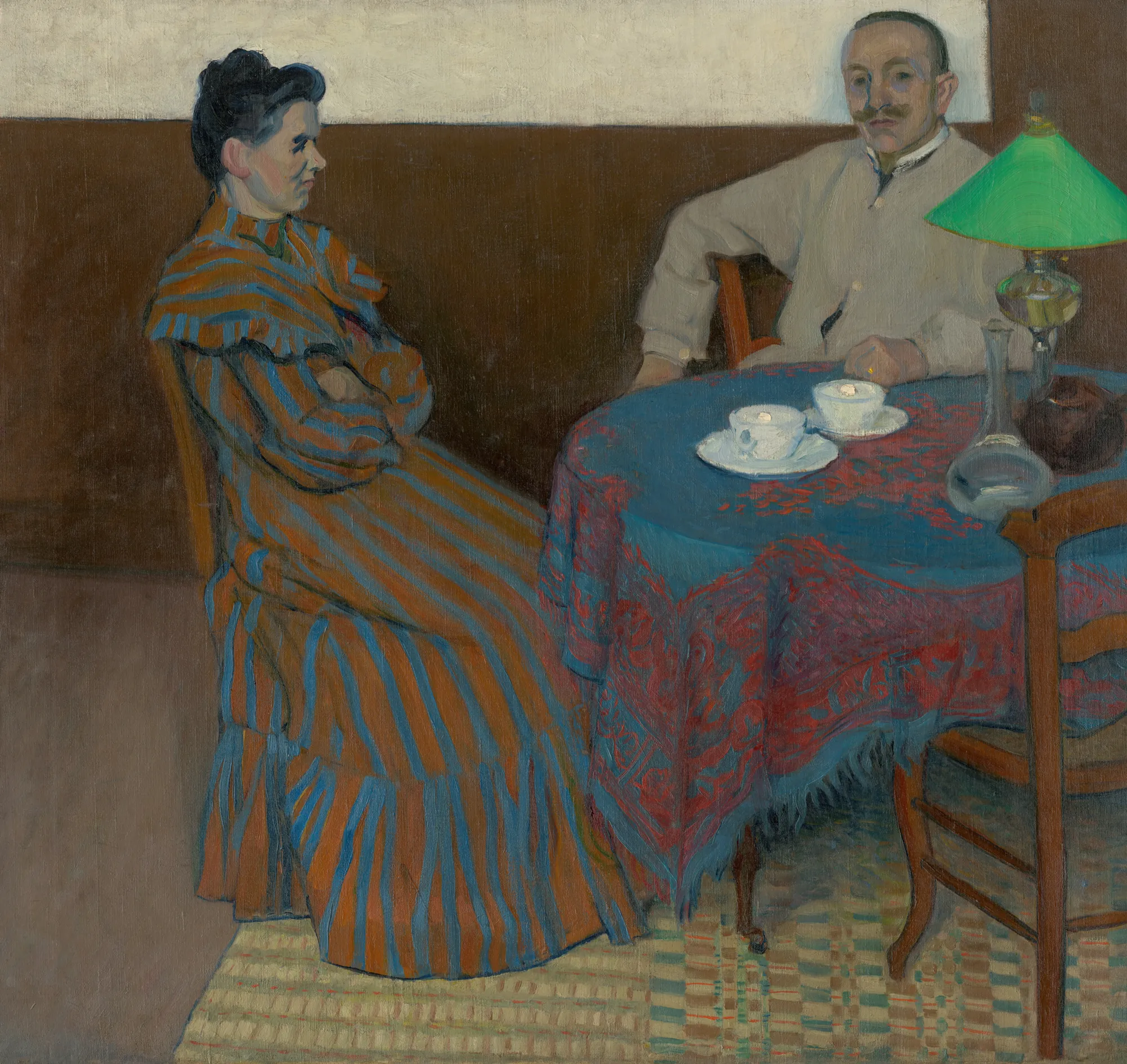 Spouses at the Table (Manželia pri stole) Spouses at the Table (Manželia pri stole) by Július Andorko. A man and woman sit at a small round table covered with a patterned blue cloth, illuminated by a green lamp.