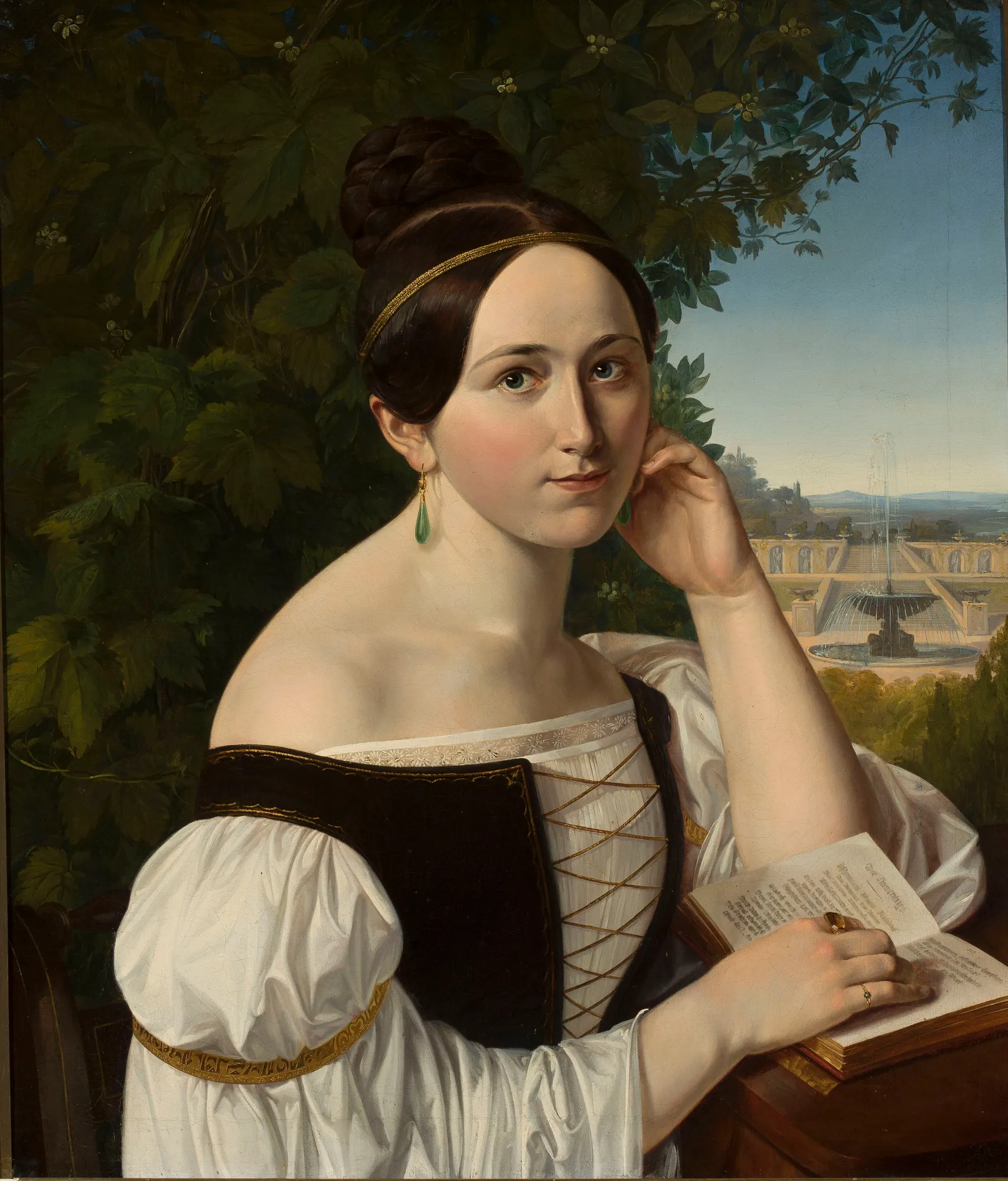 Portrait of a Young Woman with a Book in a Park