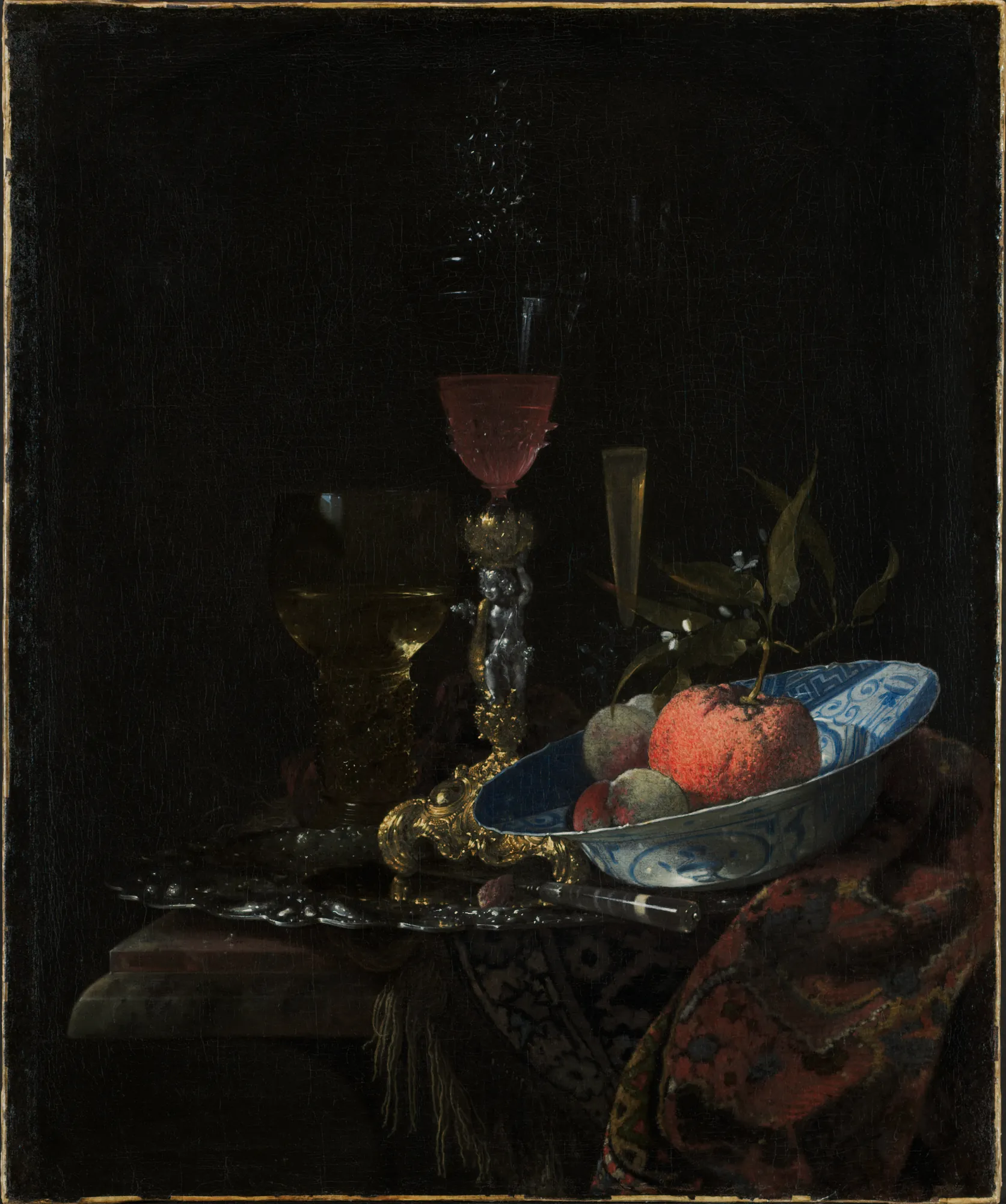 Wineglass and a Bowl of Fruit Wineglass and a Bowl of Fruit by Willem Kalf. A dramatic Dutch Golden Age still life featuring an ornate goblet, a blue-and-white porcelain bowl of fruit, and a silver tray set against a dark, moody background.