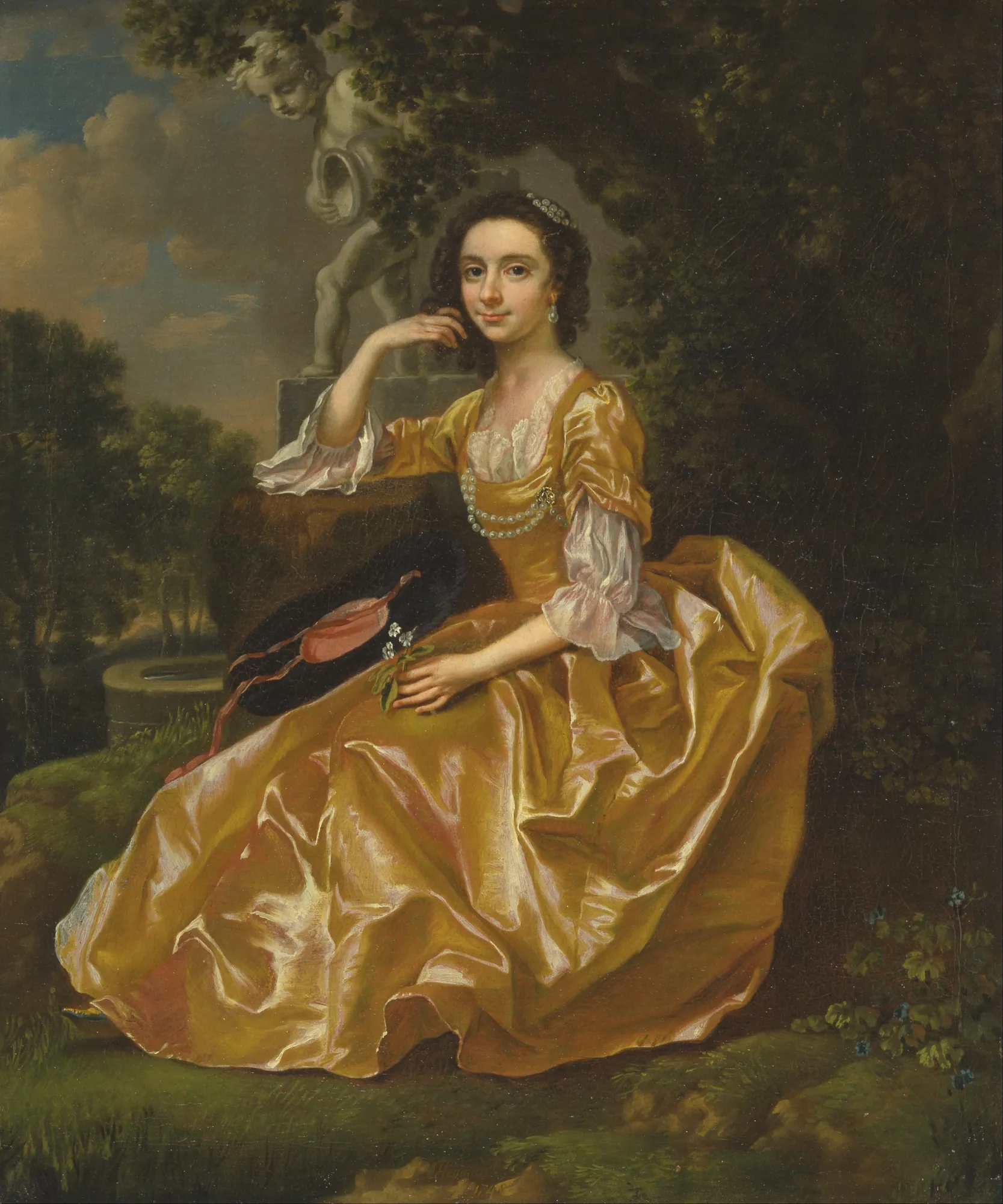 Mary Chauncey Mary Chauncey by Francis Hayman. A woman in a shimmering yellow satin gown sits in a garden landscape beside a stone cherub statue.