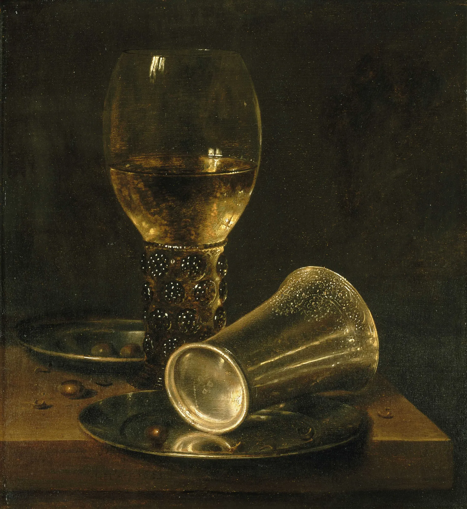 Still Life with Overturned Timbale (Nature morte à la timbale renversée) Still Life with Overturned Timbale (Nature morte à la timbale renversée) by Willem Claesz. Heda. An atmospheric still life featuring a tall glass goblet and an overturned silver beaker resting on metal plates atop a wooden table.