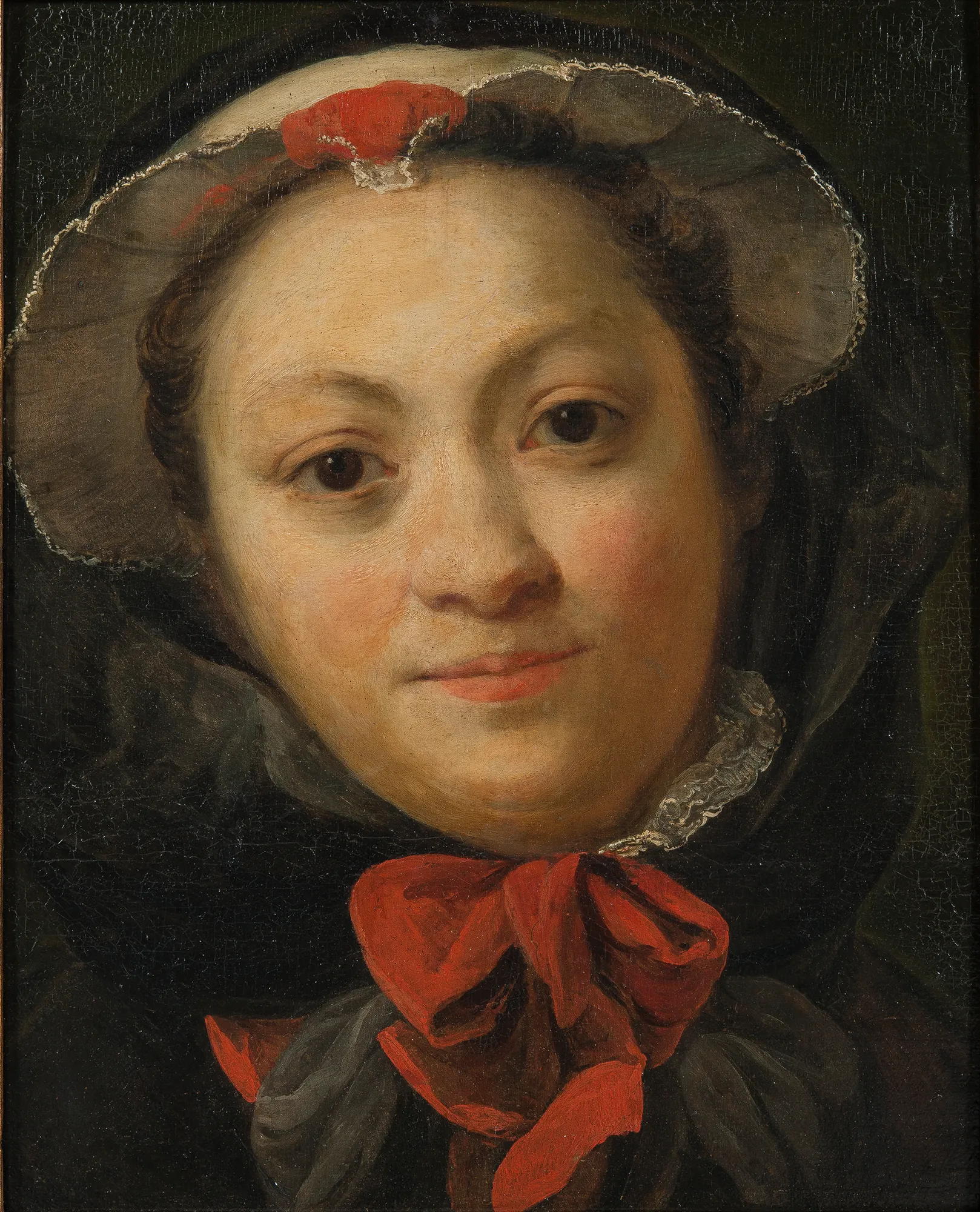 Charlotta Pilo (née Desmarées) Charlotta Pilo (née Desmarées) by Carl Gustaf Pilo. A close-up portrait of a woman wearing a white cap and a dark hood accented by vibrant red ribbons.