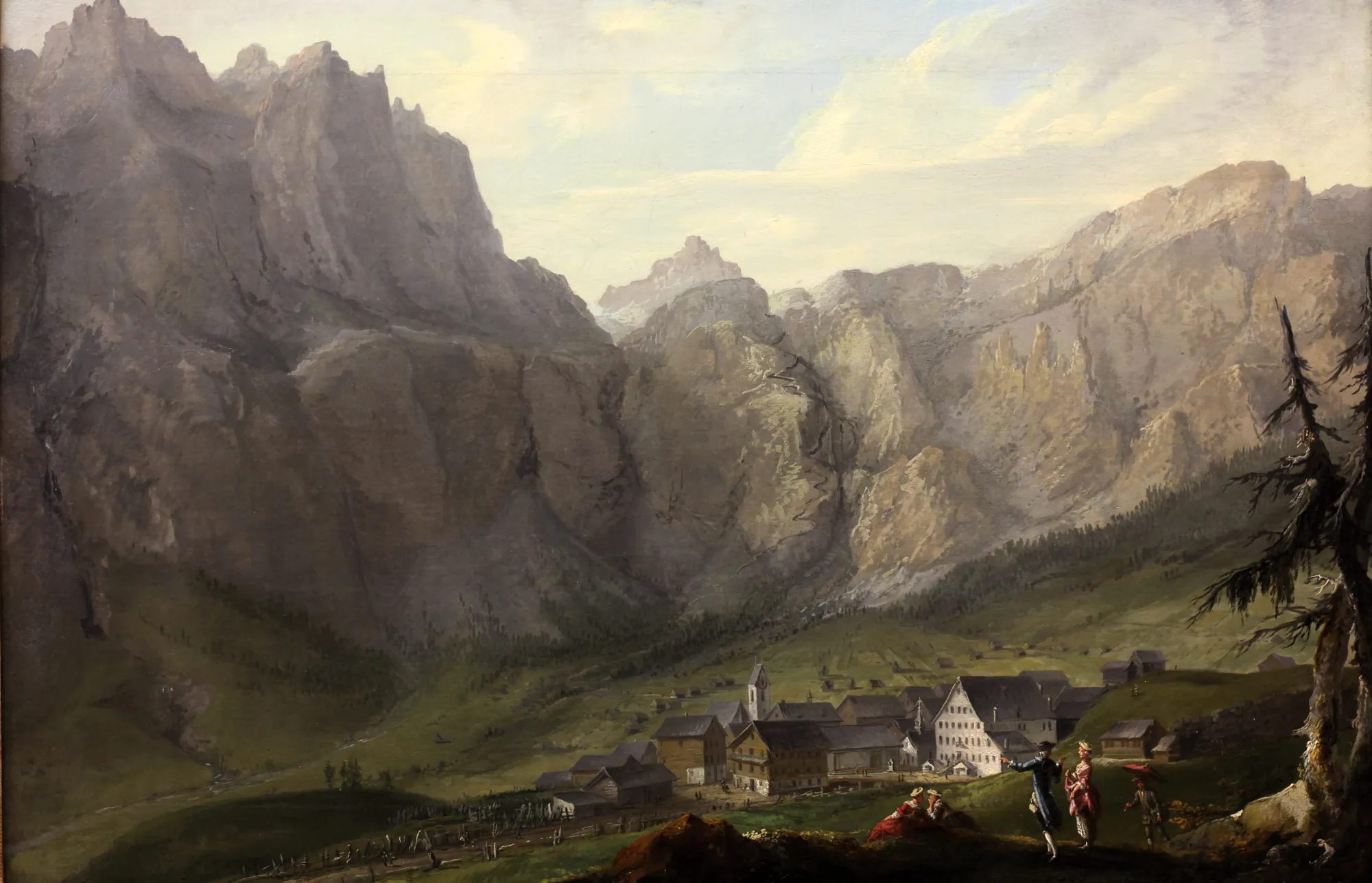 Leukerbad Leukerbad by Caspar Wolf. A grand alpine landscape depicting a small village nestled in a valley at the foot of massive, craggy mountain peaks under a soft sky.