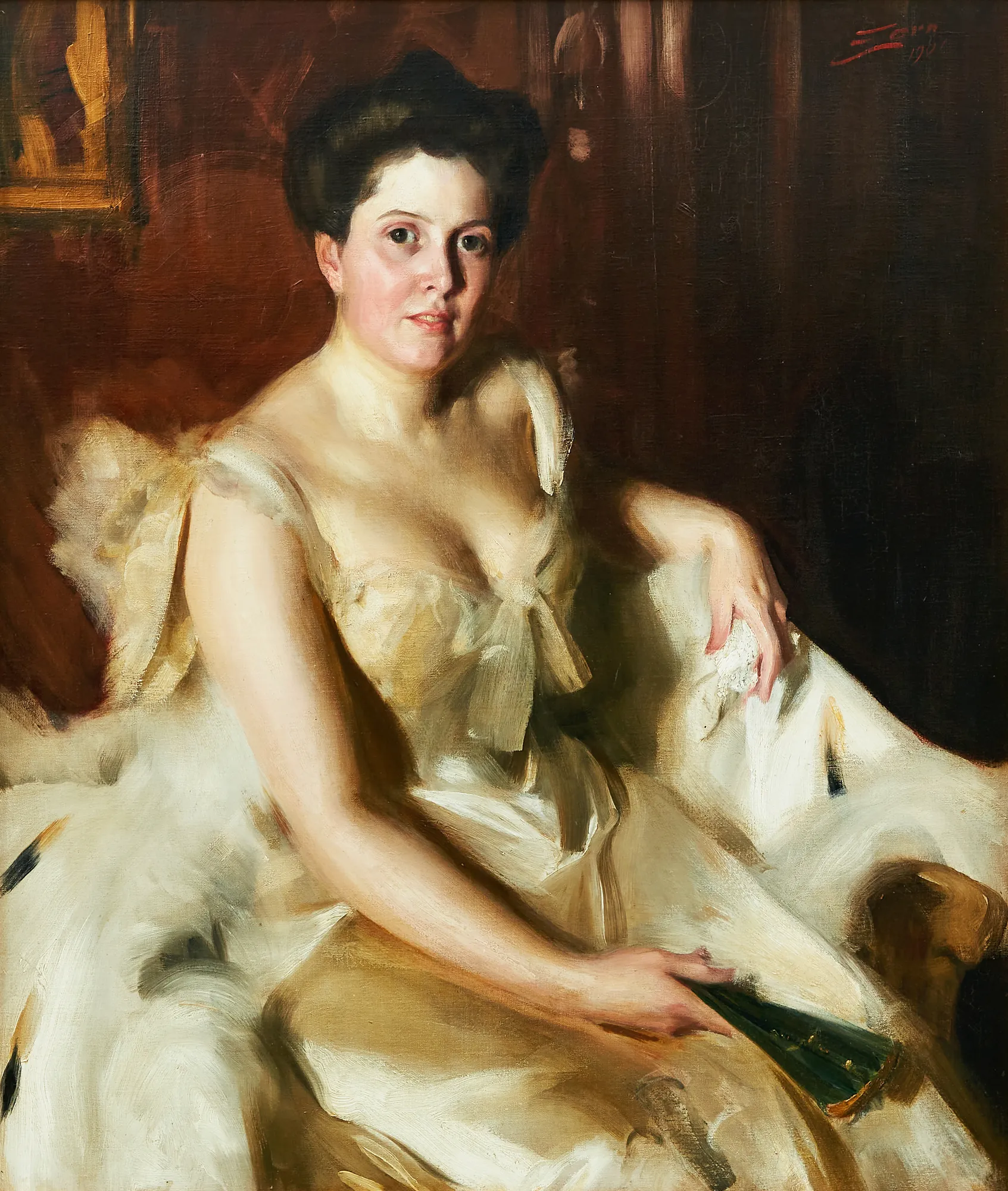 Portrait of Mrs. de Ver Warner Portrait of Mrs. de Ver Warner by Anders Zorn. A three-quarter length portrait of a dark-haired woman in an elegant cream-colored gown, seated and holding a green fan against a dark background.