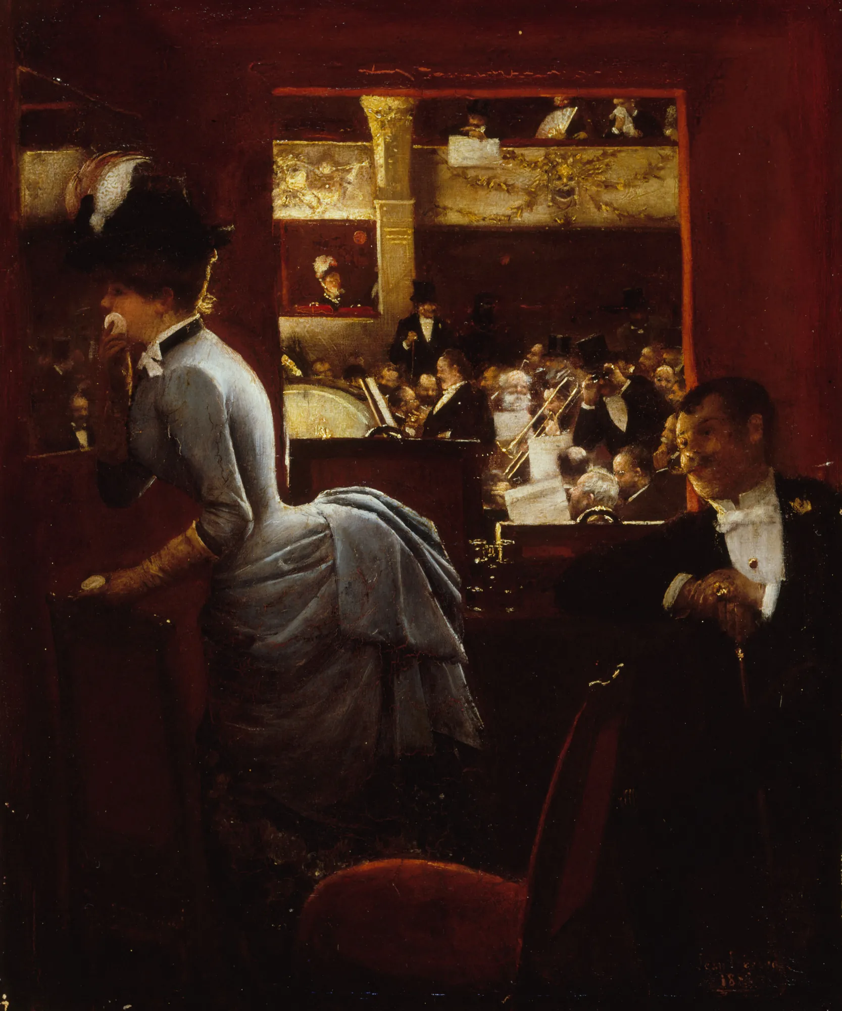 La Baignoire, au Théâtre des Variétés La Baignoire, au Théâtre des Variétés by Jean Béraud. A woman in an elegant blue gown stands in a dark red theater box overlooking a crowded orchestra and audience.