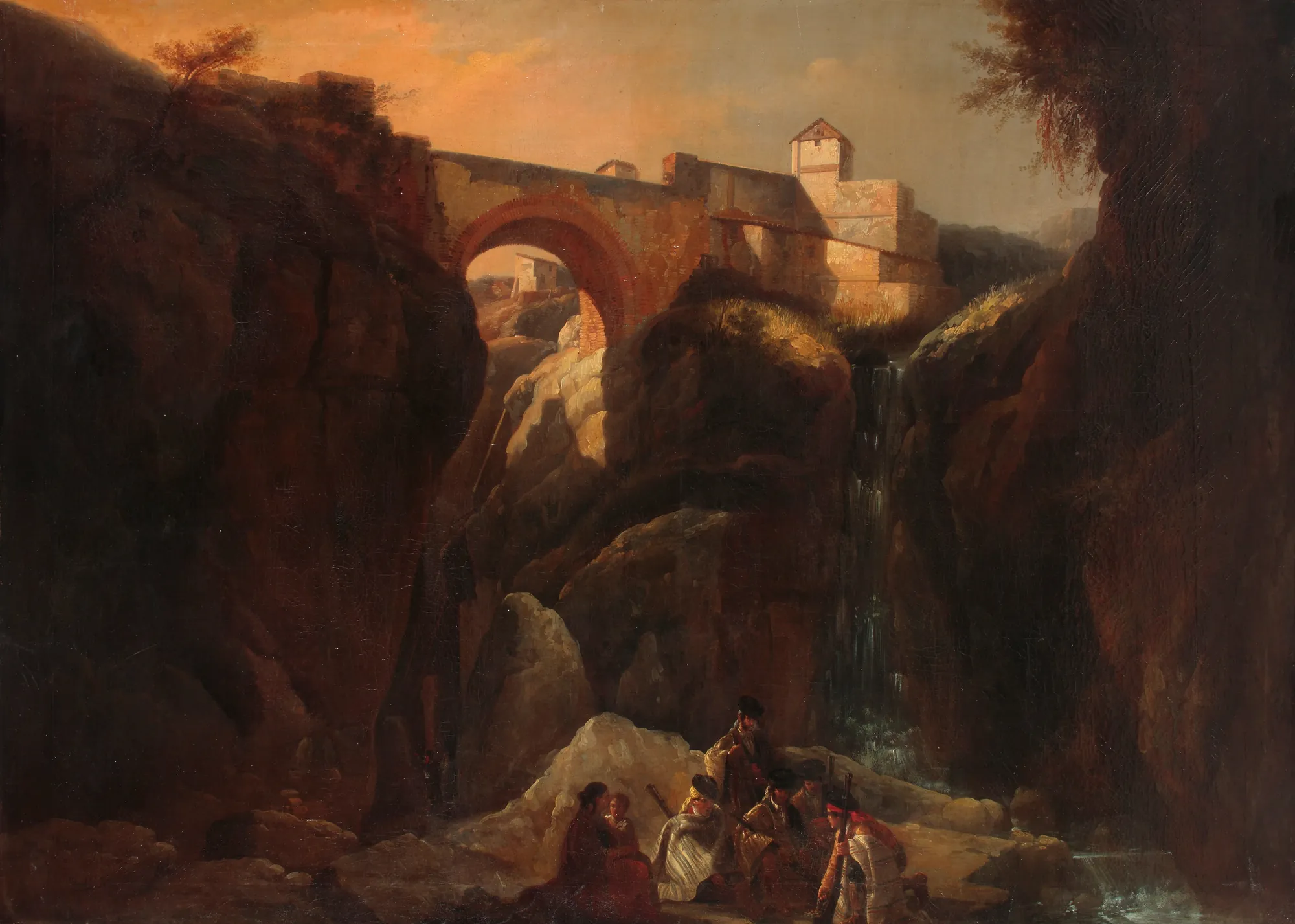 Smugglers in the Ronda Hills Smugglers in the Ronda Hills by Manuel Barrón y Carrillo. A group of figures congregates in a dark, rocky gorge beneath a towering stone bridge under a warm, glowing sky.