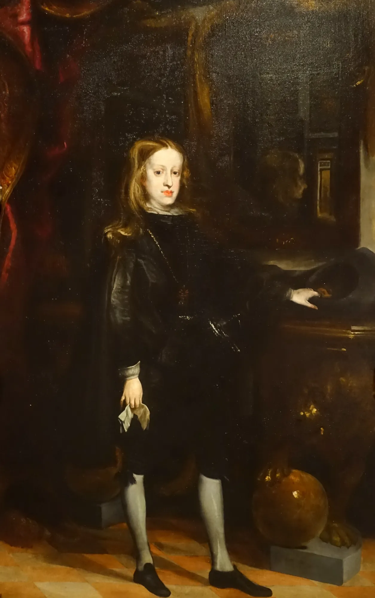King Charles II King Charles II by Juan Carreño de Miranda. A full-length oil portrait of a young King Charles II of Spain, standing in a dark, ornate hall with a lion at his feet.