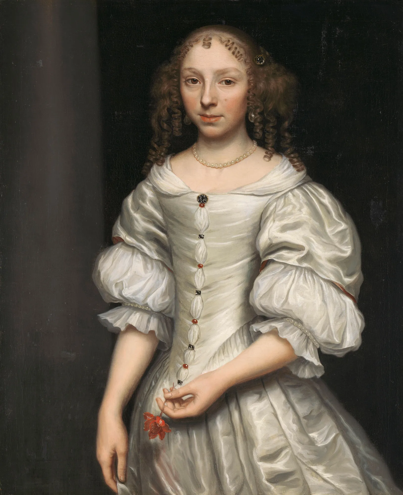 Portrait of a Woman Portrait of a Woman by Wallerant Vaillant. A three-quarter length portrait of a young woman with curly brown hair, wearing a shimmering white satin dress with red accents and holding a small red flower.