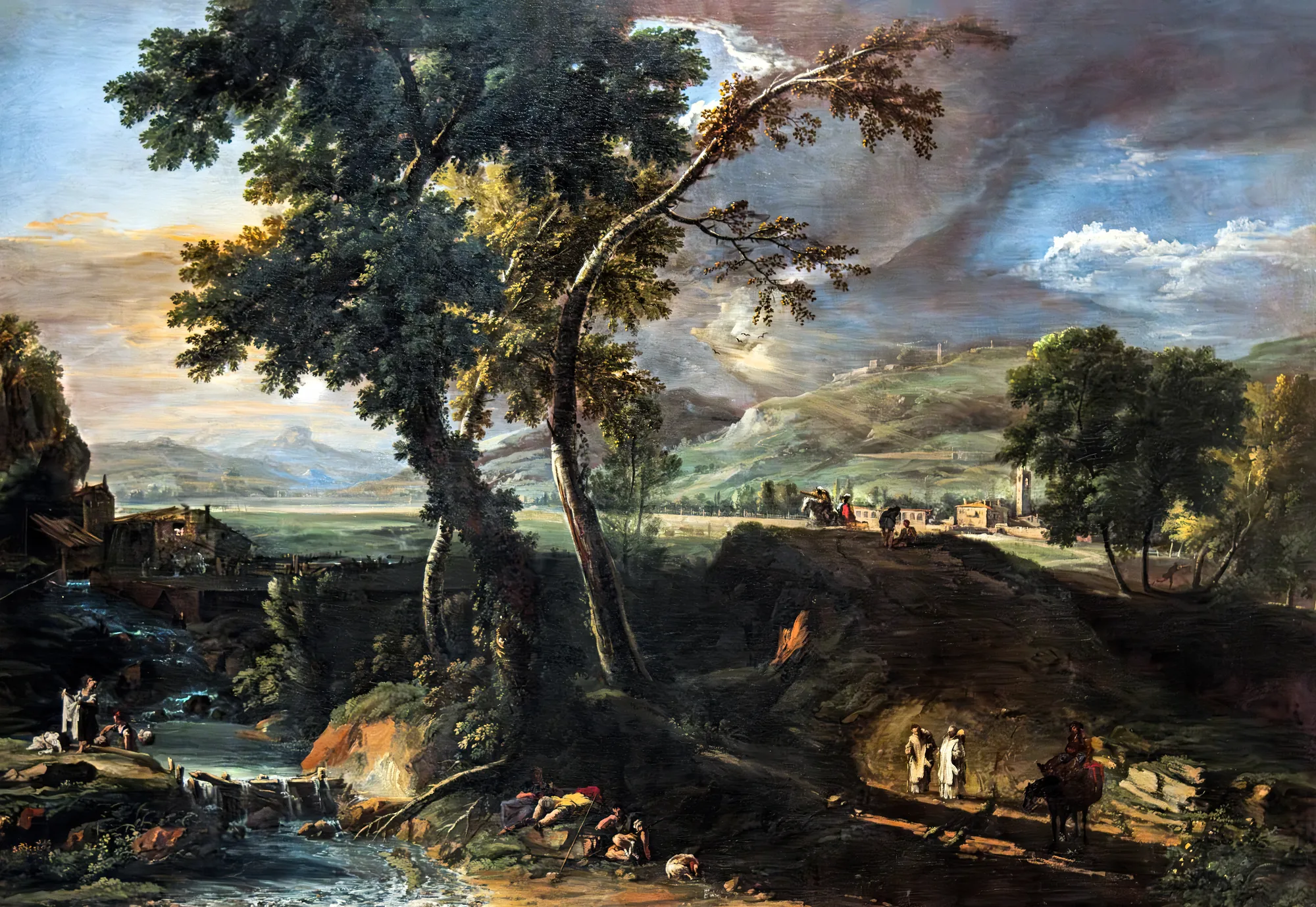 Landscape with Streams, Monks, and Washerwomen Landscape with Streams, Monks, and Washerwomen by Marco Ricci. A panoramic landscape featuring tall, windswept trees and a rushing stream where figures wash clothes, set beneath a dramatic, storm-filled sky.