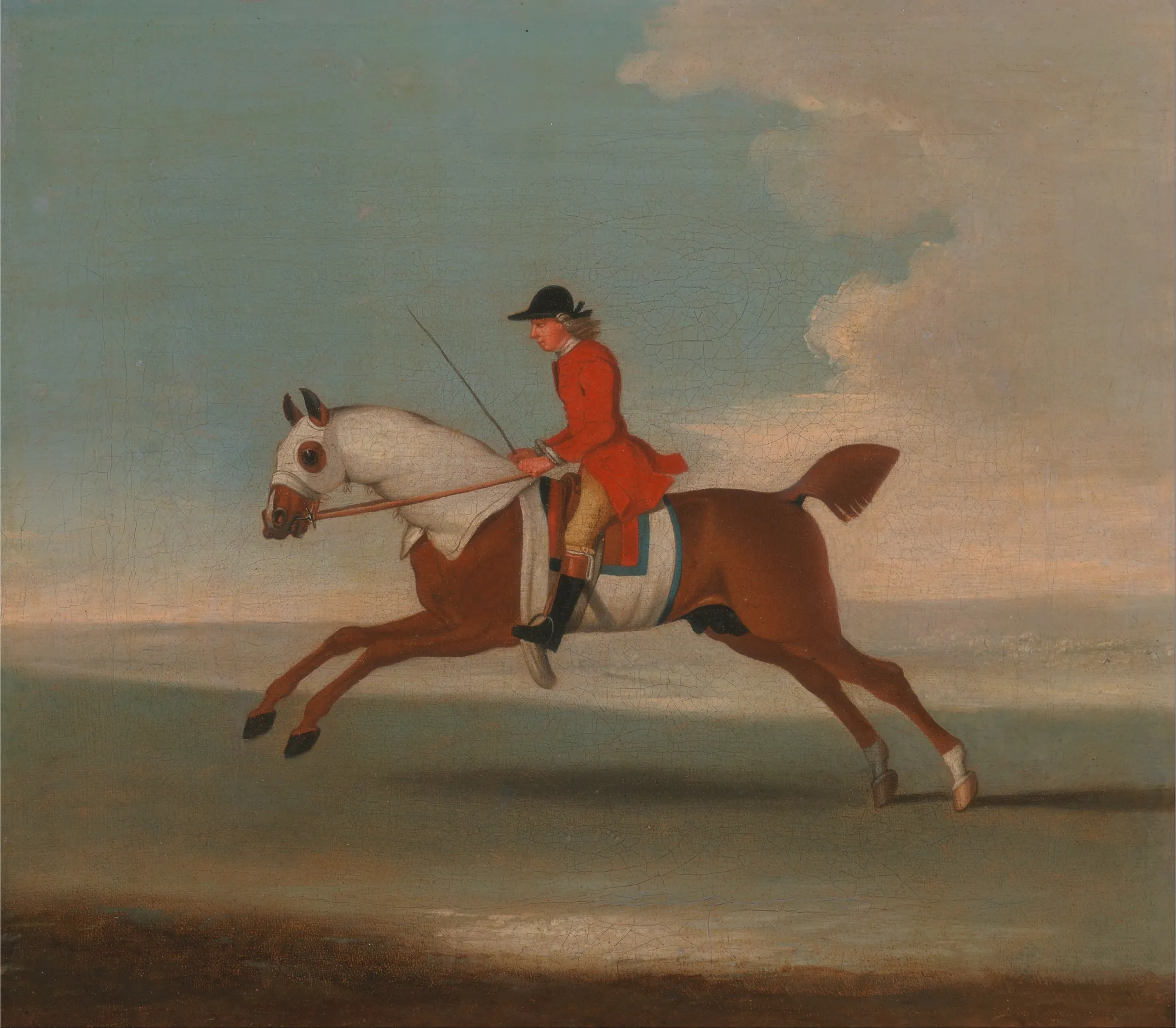 Chestnut Racehorse Exercised by a Trainer in a Red Coat