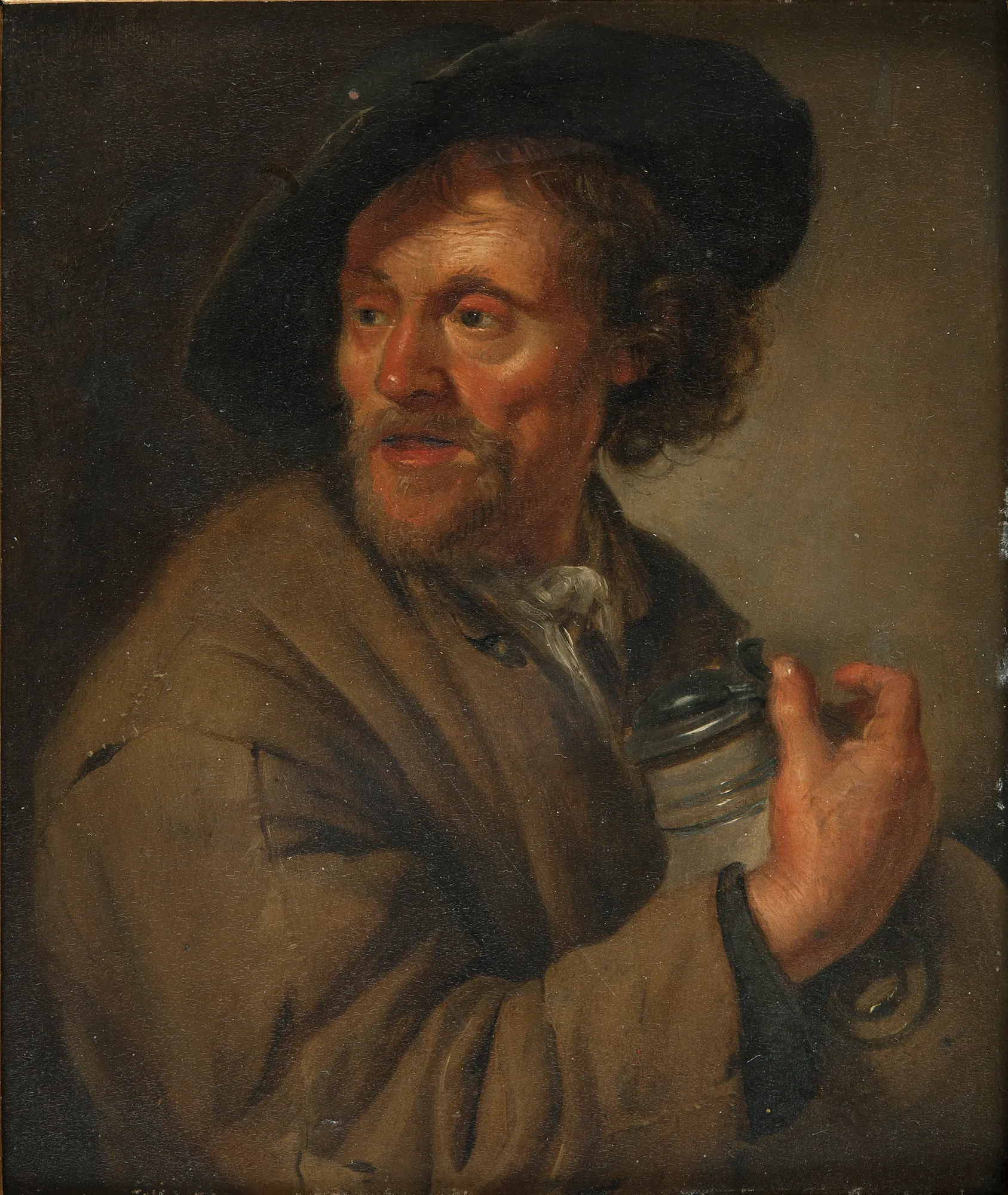 Man Holding a Jug Man Holding a Jug by Jacob Toorenvliet. A bearded man wearing a dark hat and brown coat holds a pewter-topped jug while looking off to the side.
