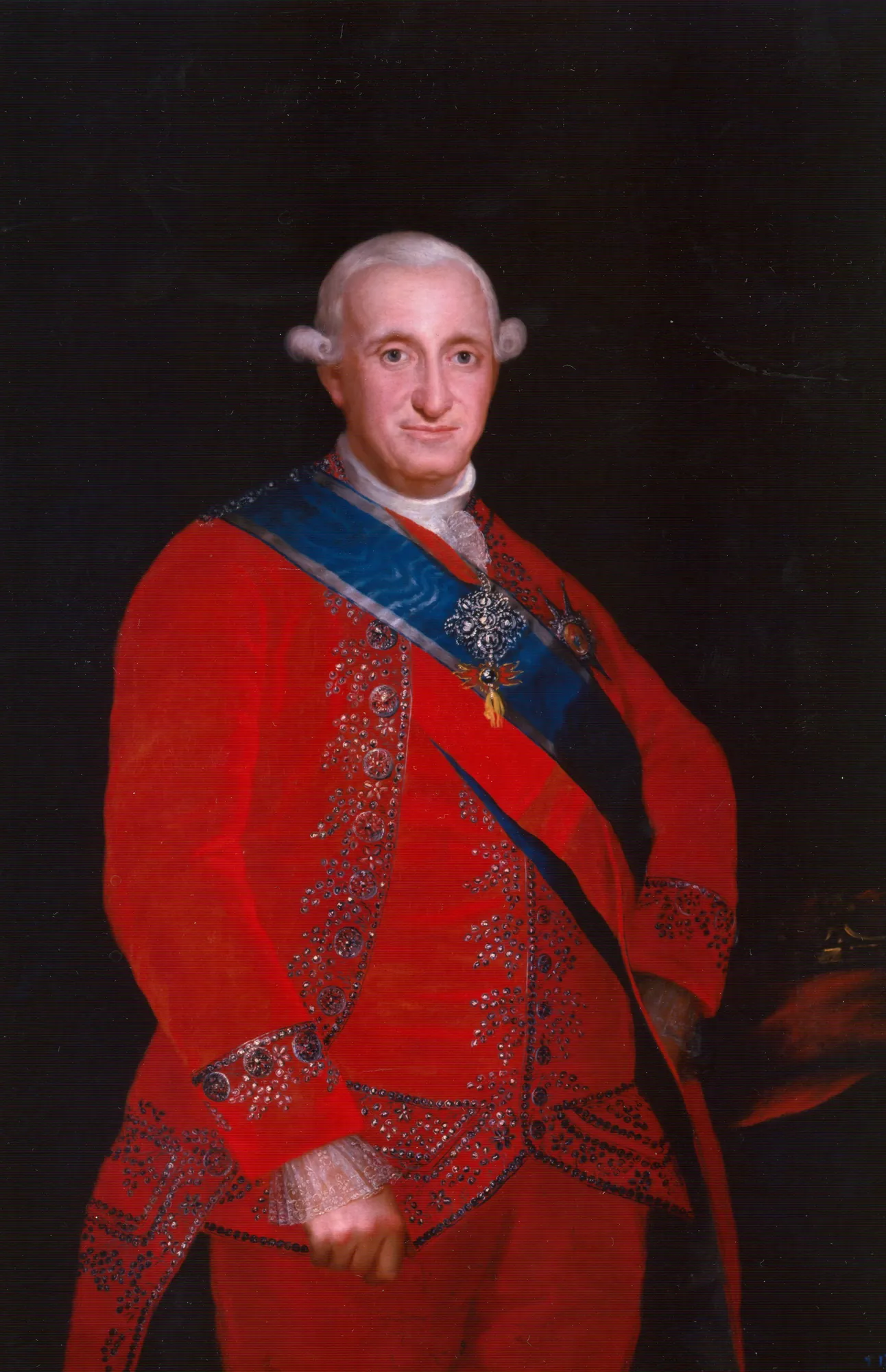 Charles IV Charles IV by Agustín Esteve. A waist-length formal portrait of King Charles IV of Spain wearing a vibrant red uniform with intricate silver embroidery and a blue sash.