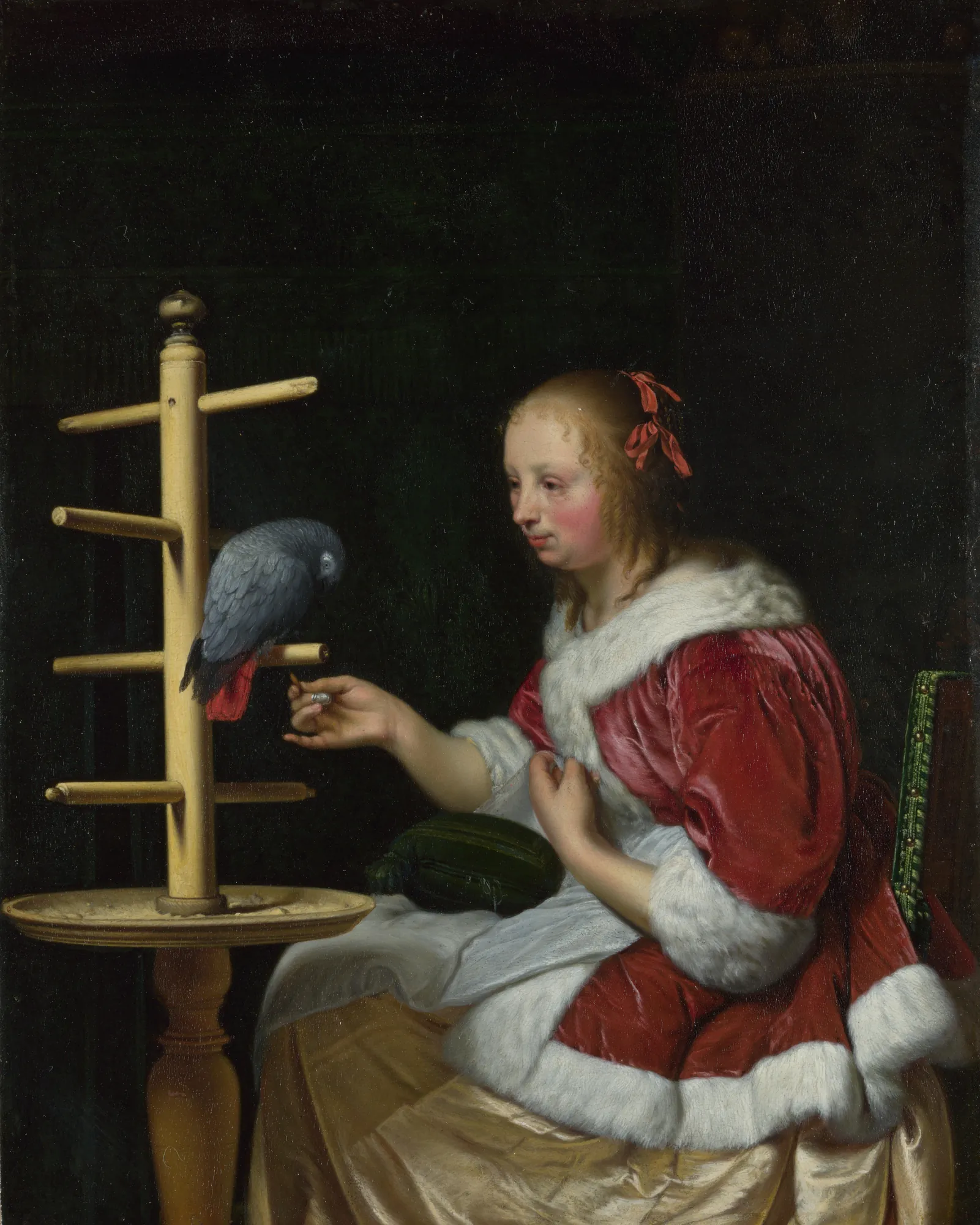 A Woman in a Red Jacket Feeding a Parrot