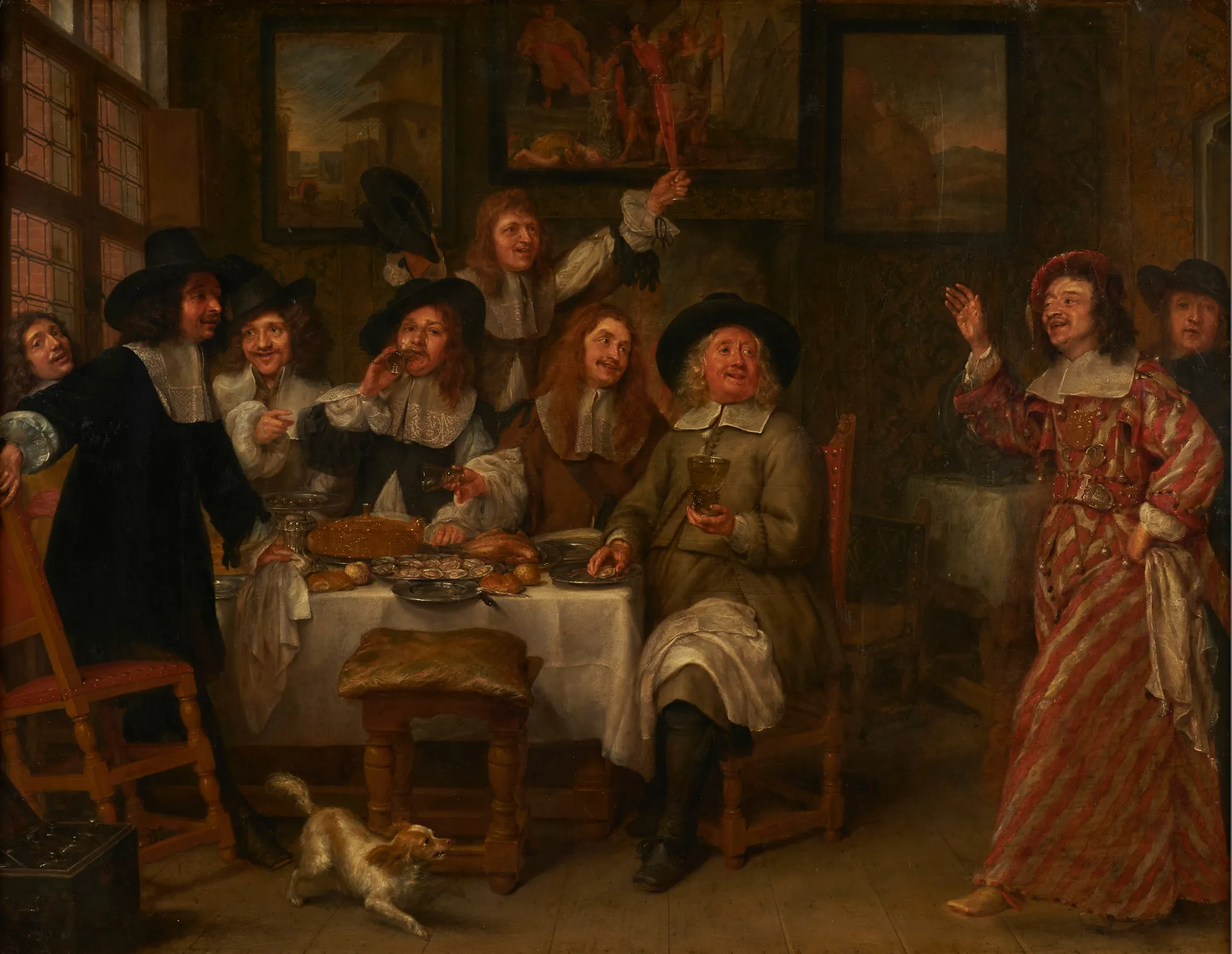 Dinner of Artists Dinner of Artists by Gonzales Coques. A group of seventeenth-century men in ruff collars and hats gathered around a table spread with oysters and wine, while one man in striped attire gestures on the right.