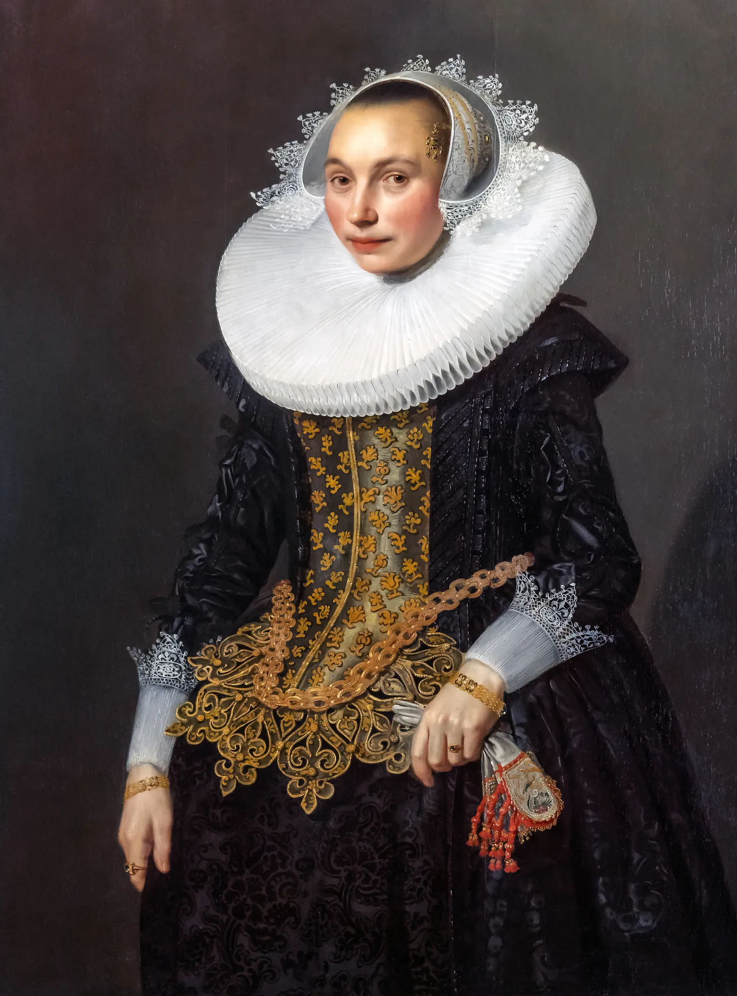 Portrait of a Woman Portrait of a Woman by Michiel Jansz. van Mierevelt. A high-contrast three-quarter length portrait of a woman wearing a black gown, gold-embroidered bodice, and an immense white millstone ruff.