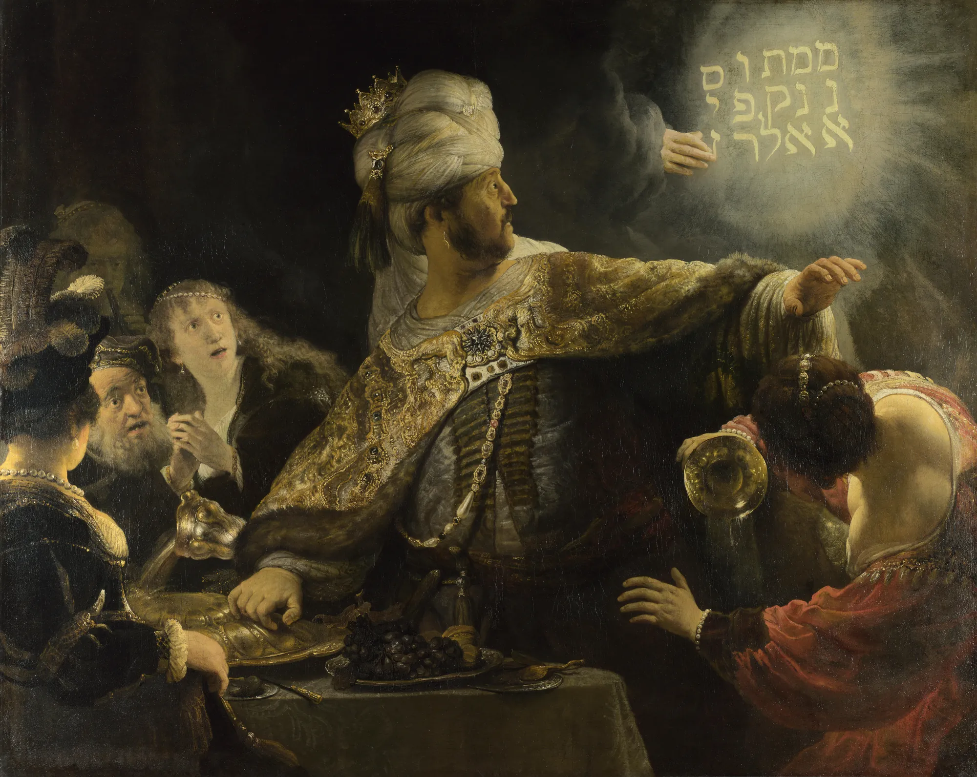 Belshazzar's Feast Belshazzar's Feast by Rembrandt. A large-scale dramatic scene where a king in ornate robes recoils from a divine hand writing Hebrew letters on a wall in glowing light.